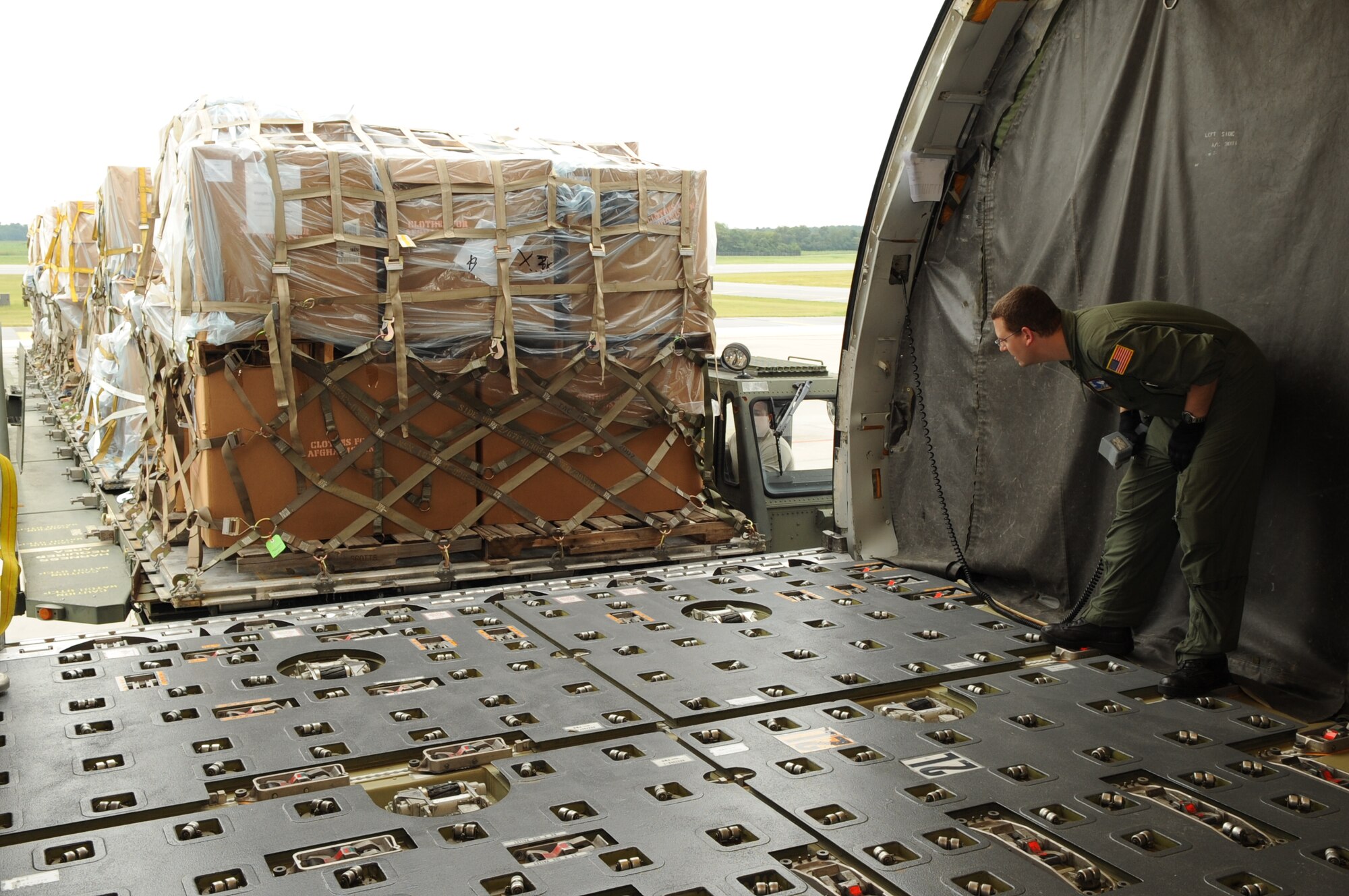 SEYMOUR JOHNSON AIR FORCE BASE, N.C. – Tech. Sgt.  Daniel Timko checks cargo alignment as it is loaded onto a KC-10 Extender here, Sept. 2, 2010. The cargo is donated humanitarian supplies and winter clothes collected through the Goldsboro MERCI Center.  The donations will be distributed to Afghan communities during humanitarian aid missions. Sergeant Timko, 76th Air Refueling Squadron boom operator instructor, is from Stratford, N.J. (U.S. Air Force photo/Staff Sgt. Courtney Richardson) (RELEASED)