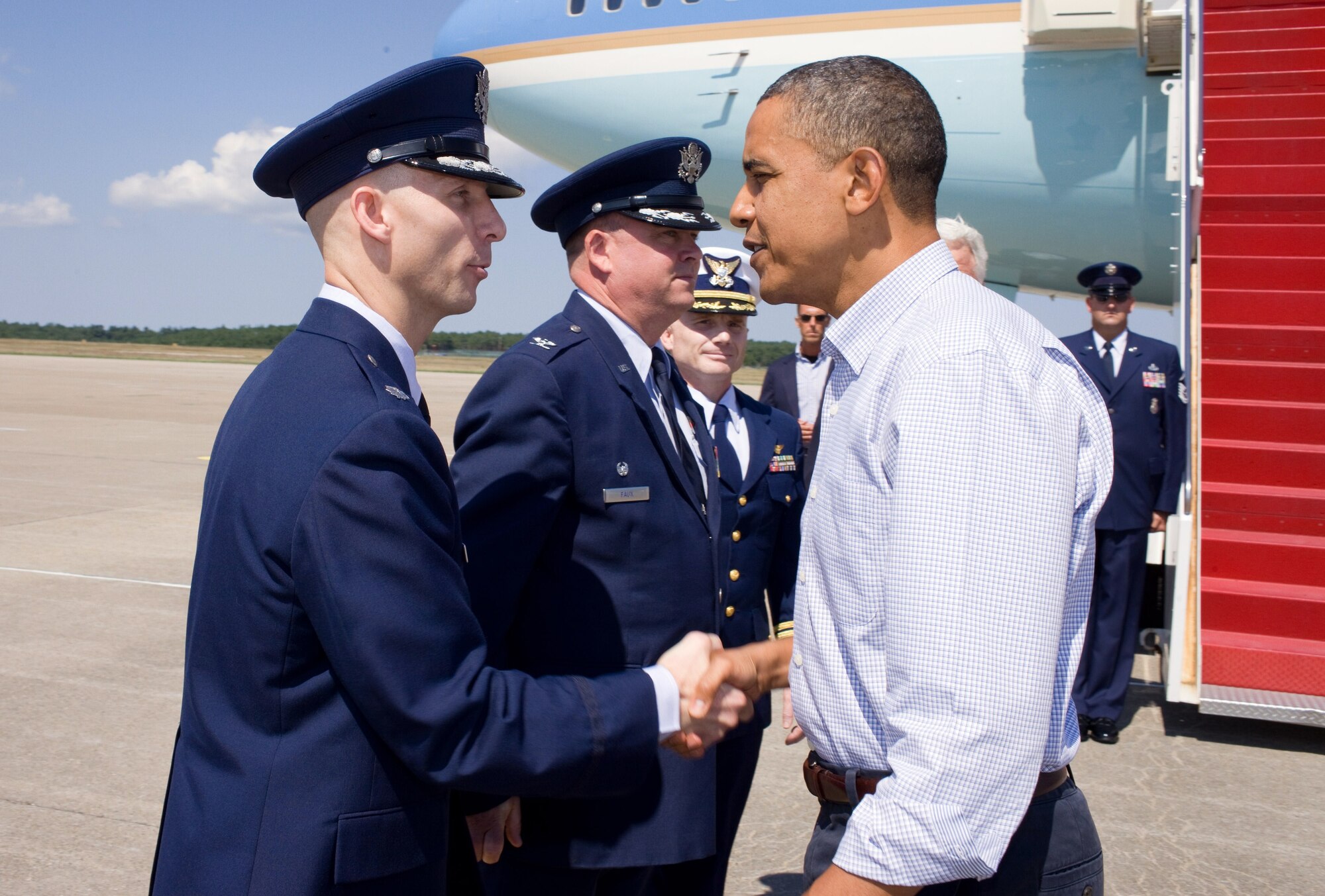MASSACHUSETTS MILITARY RESERVATION, Mass. -- President Barack Obama greets Lt. Col. Shawn Smith, 6th Space Warning Squadron commander, upon his arrival at U.S. Coast Guard Air Station Cape Cod on the Massachusetts Military Reservation, Aug. 19. (Official White House photo/Pete Souza)