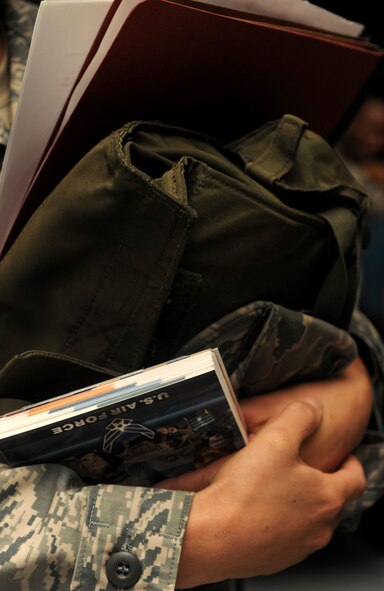 MOODY AIR FORCE BASE, Ga. -- A member of the 476th Fighter Group carries her Airman’s Manual, gas mask and medical records as she processes a deployment line here Aug. 24. The gas mask of each deploying member was inspected in conjunction with their medical records. (U.S. Air Force photo/Airman 1st Class Benjamin Wiseman)