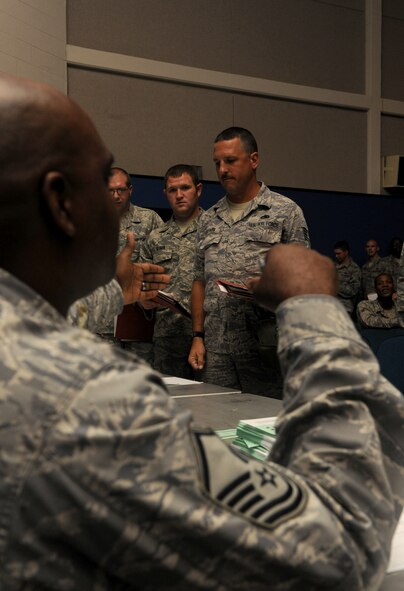 MOODY AIR FORCE BASE, Ga. -- Master Sgt. Stanley Byron, 23rd Force Support Squadron readiness NCO, checks registration cards as members of the 23rd Fighter Group and 476th Fighter Group process through a deployment line here Aug. 24. Airmen from several Moody agencies such as finance and medical ensure members of the 23rd FG and 476th FG are prepared for deployment. (U.S. Air Force photo/Airman 1st Class Benjamin Wiseman)