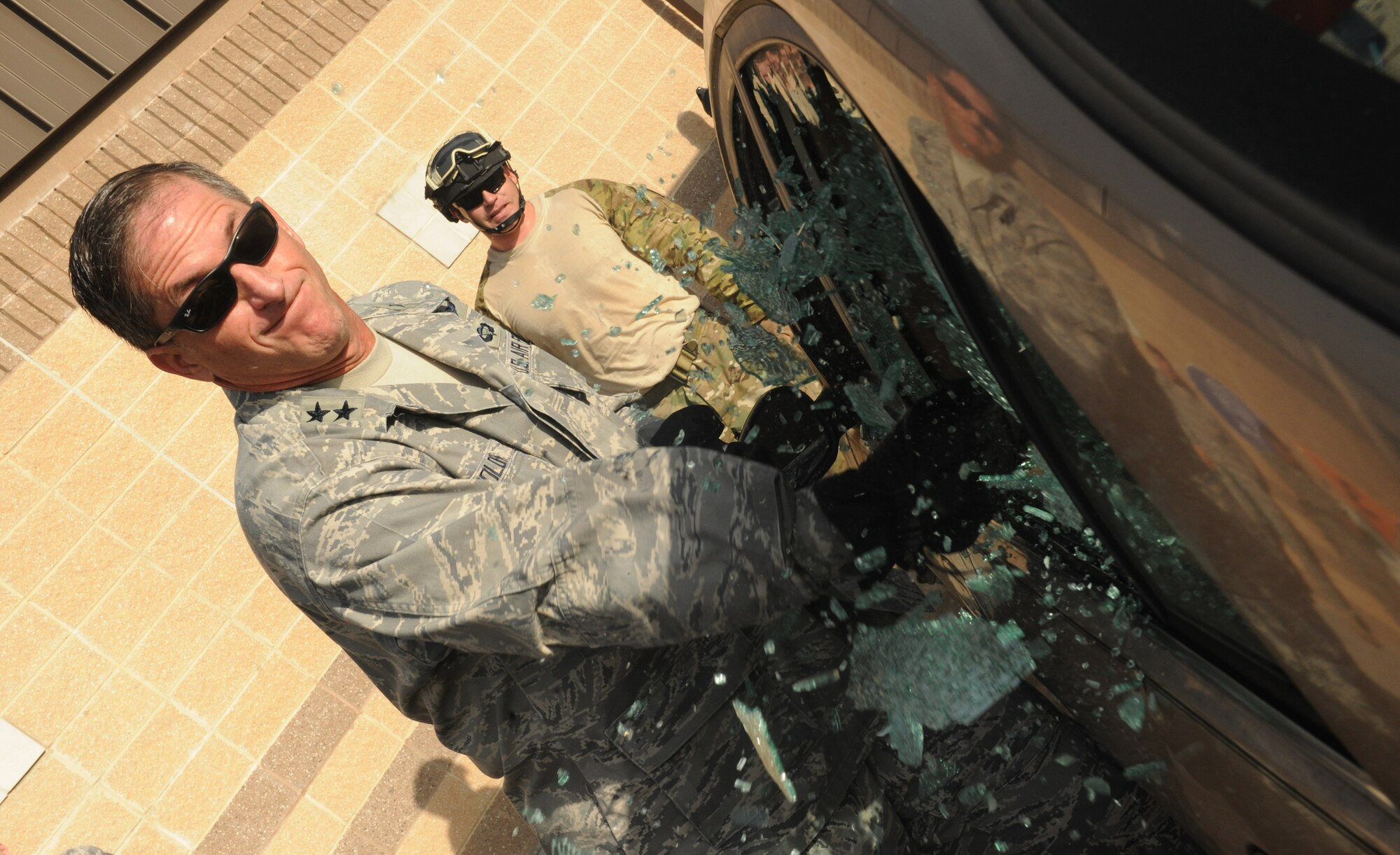 MOODY AIR FORCE BASE, Ga. -- Maj. Gen. David Goldfein, Air Combat Command director of air and space operations, shatters a car rear window with a crash axe while participating in a confined spaces rescue scenario with the 38th Rescue Squadron here Aug. 31. General Goldfein was able to meet Airmen from different squadrons within the 347th Rescue Group during his visit. (U.S. Air Force photo/Airman 1st Class Benjamin Wiseman)