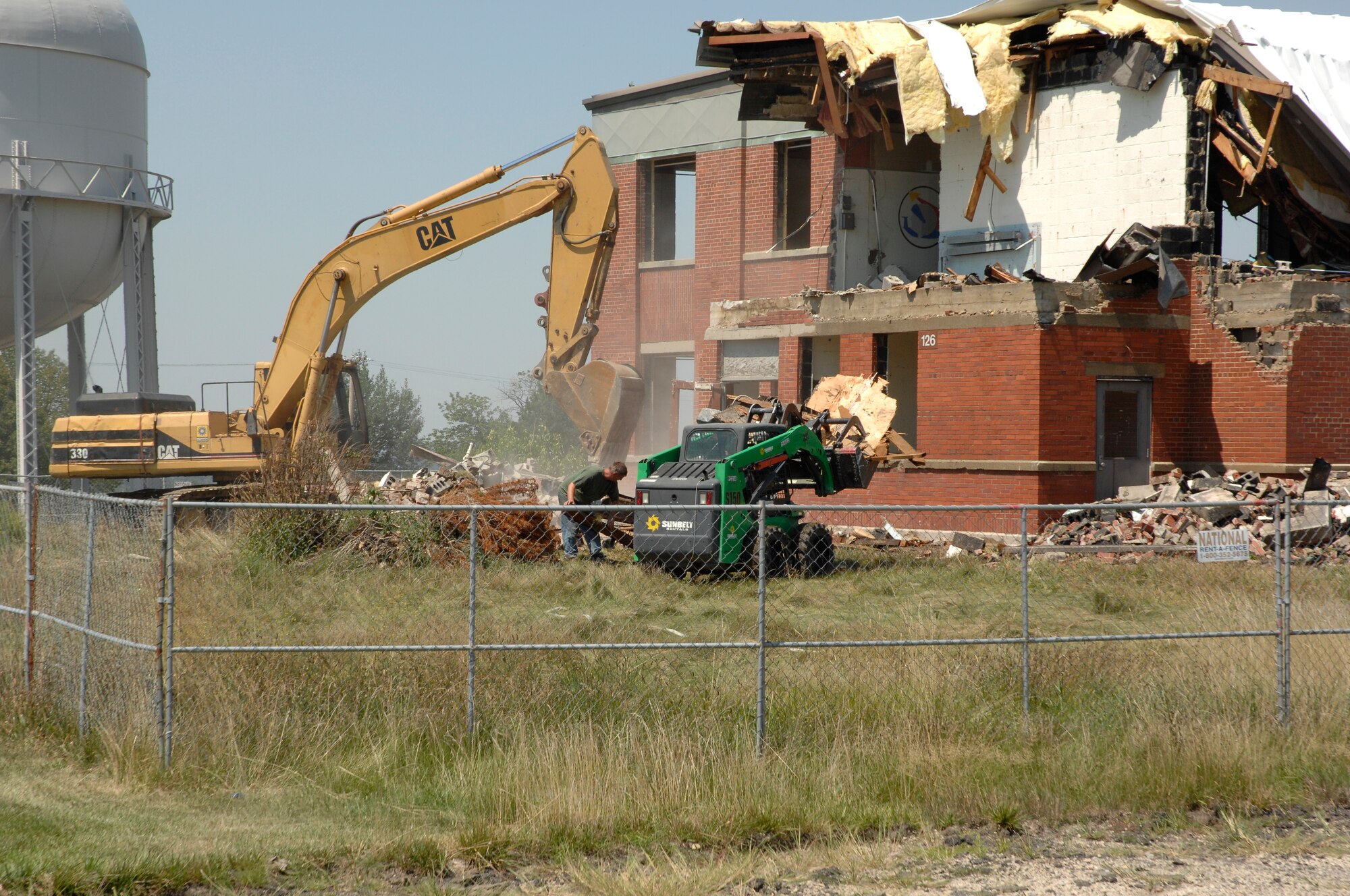 Wright-Patterson Air Force Base civil engineers expect the demolition of Building 126 in Area B to be completed in mid September to make way for a new Information Technology Complex.  Originally constructed in 1944 as the Headquarters Building Engineering Division, the building once featured a large wall mural titled “Wright Field,” painted in 1945 by artist Sgt. Stuyvesant Van Veen.  The painting, which portrays the World War II flightline of Wright Field, was accessed into the Air Force Art Collection and is in storage at Joint Base Andrews,  Md, and is a candidate for future restoration.  The U.S. Army Corps of Engineers Louisville District Office will oversee construction of the Information Technology Complex, Phase I project. (U.S. Air Force photo/Michelle Gigante)