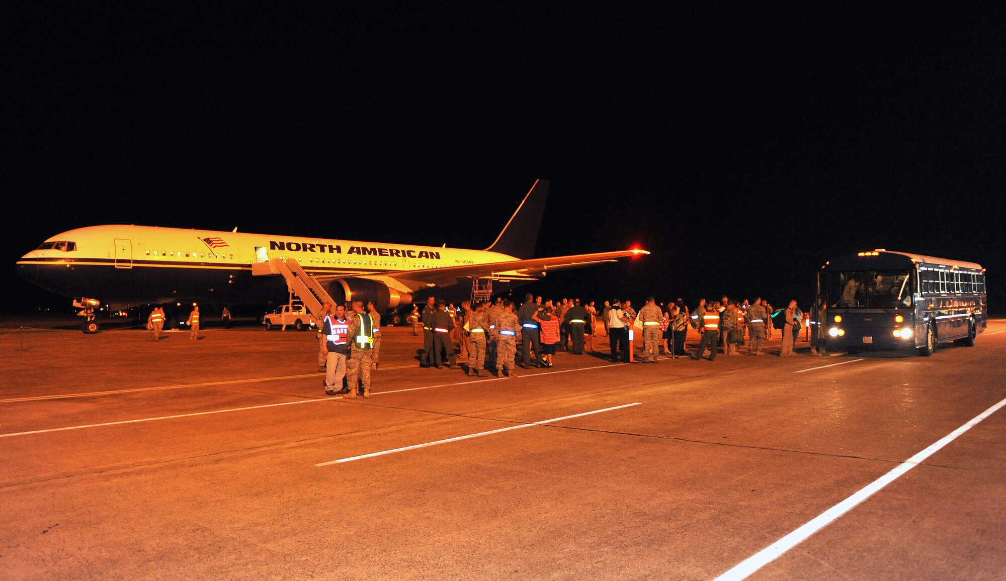 Team Little Rock Members make the transition from a rotator aircraft to the base buses Sept. 1.  Base leaders, friends and families welcomed home more than 160 Airmen returning from deployments in Southwest Asia.  (U.S. Air Force photo by Staff Sgt. Chris Willis)