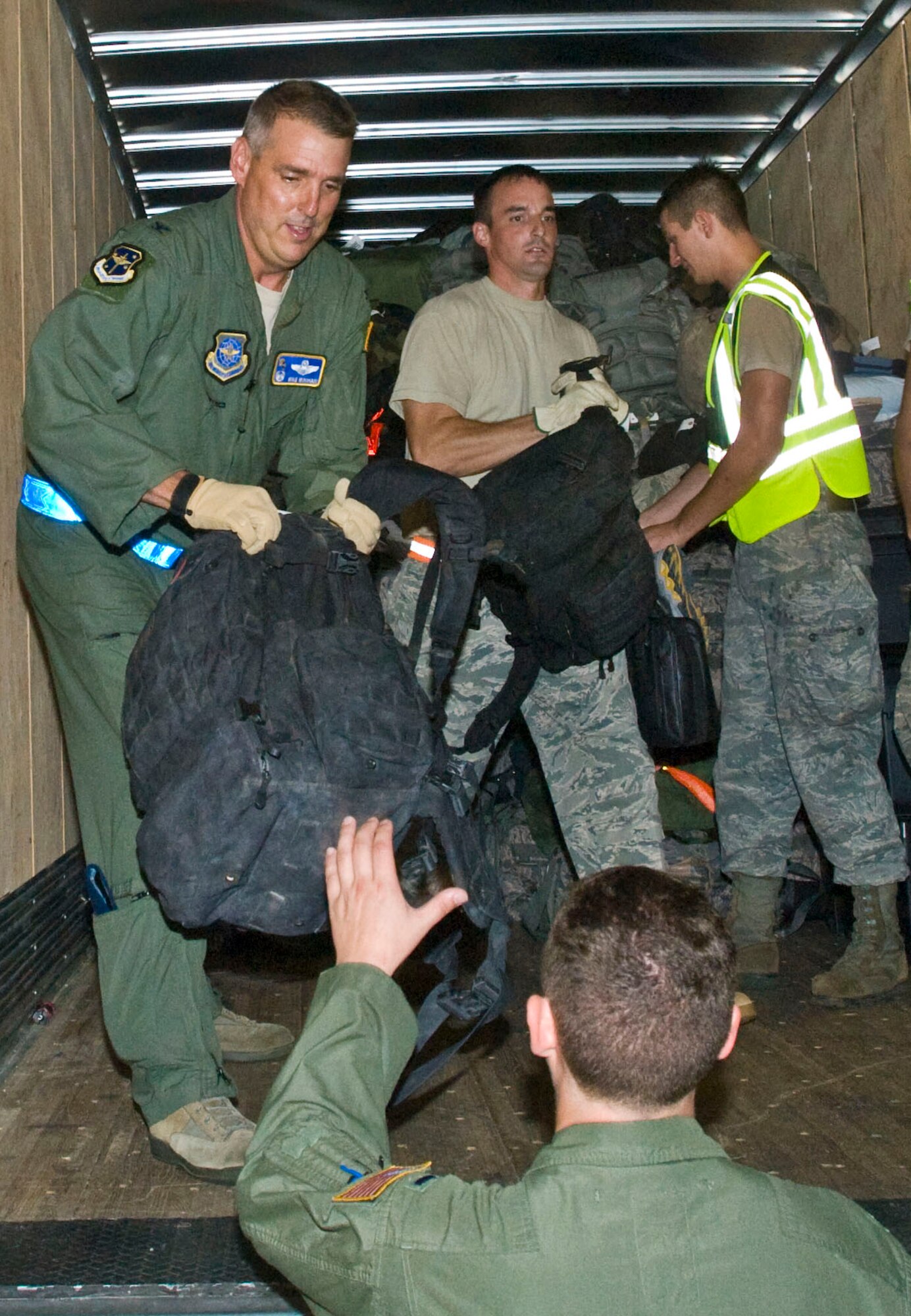 Col. Mike Minihan (left), 19th Airlift Wing commander, lends a hand during the bagdrag of deployed Airmen's luggage Sept. 1 at the Little Rock Air Force Base passenger terminal. More than 160 Airmen returned home from deployments in Southwest Asia. (U.S. Air Force photo by Staff Sgt. Nestor Cruz)