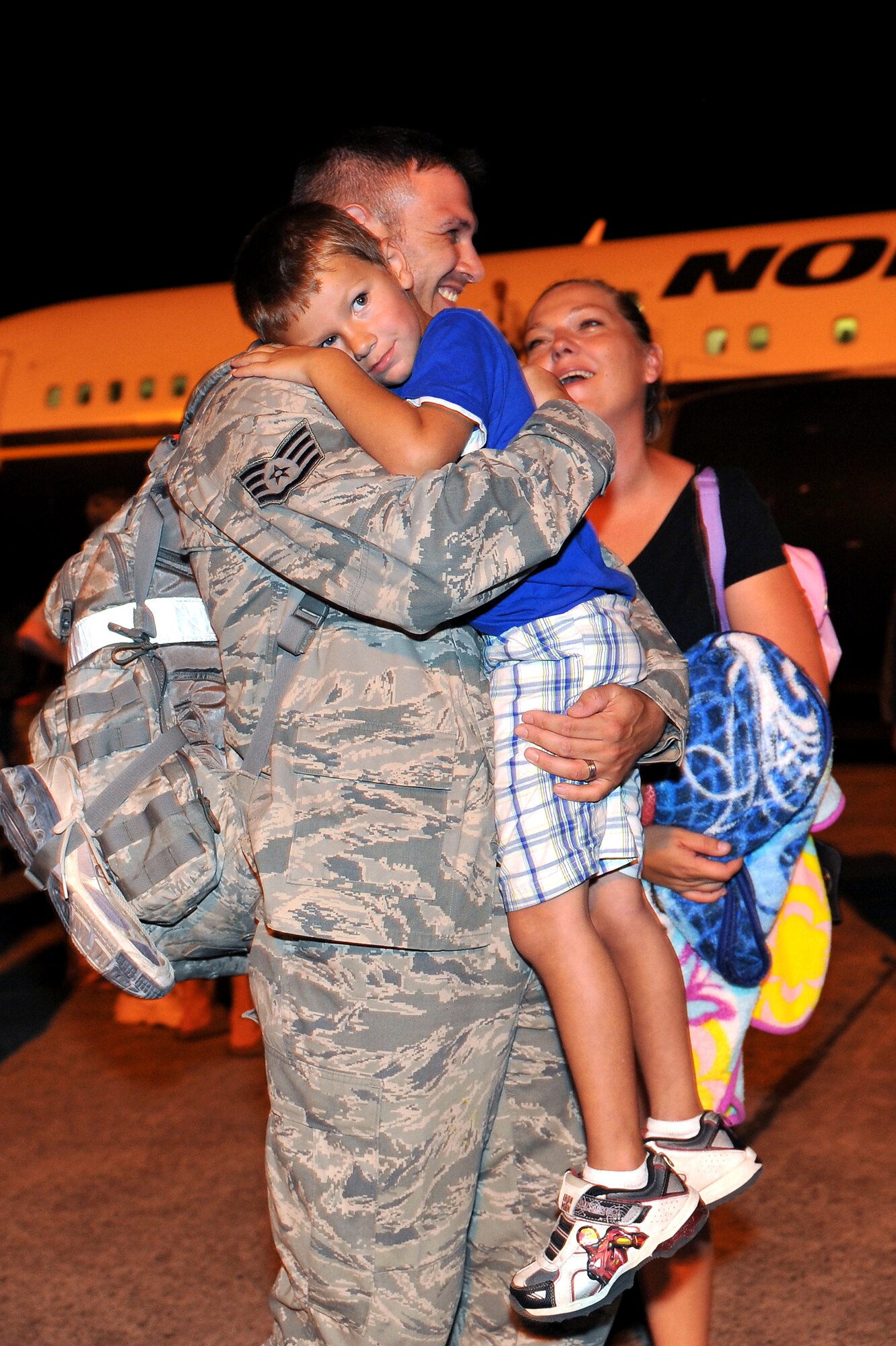 Staff Sgt. Francisco Velasquez, 19th Equipment Maintenance Squadron aircraft structural maintenance craftsman, shares a moment with his son, Aden, and wife, Amanda, on the base flightline Sept. 1.  Base leaders, friends and families welcomed home more than 160 Airmen returning from deployments in Southwest Asia. (U.S. Air Force photo by Staff Sgt. Chris Willis)