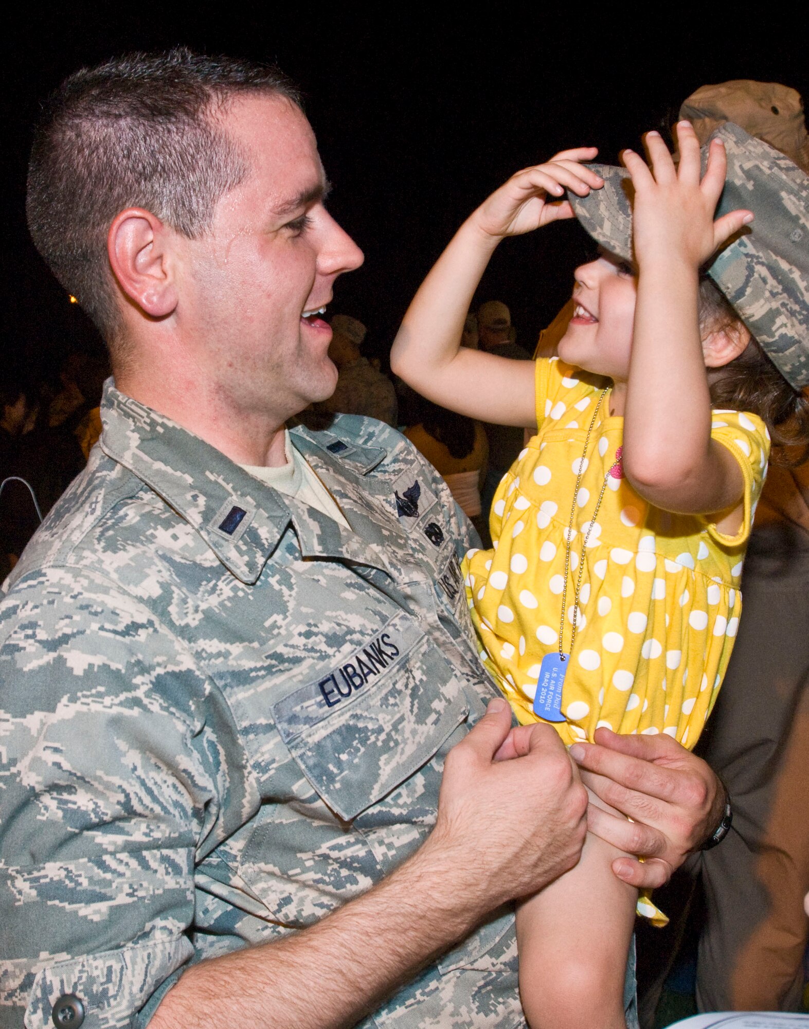Ryleigh Eubanks, 3, tries on a hat belonging to her father, 1st Lt. Cory Eubanks, 19th Aircraft Maintenance Squadron, Sept. 1 at the Little Rock Air Force Base passenger terminal. Family members, friends and base leaders came out to welcome home more than 160 Airmen returning from deployments in Southwest Asia. (U.S. Air Force photo by Staff Sgt. Nestor Cruz)