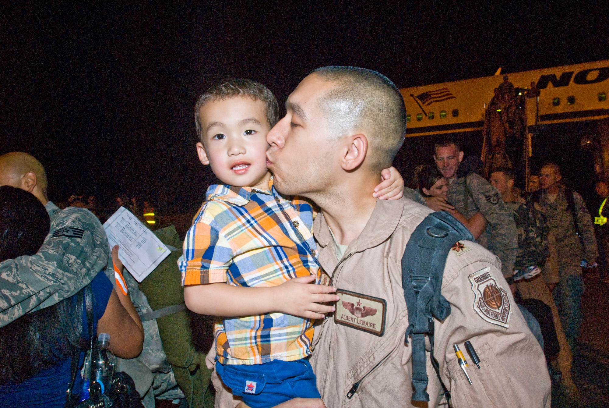 Maj. H. Albert Lemaire, 19th Operations Support Squadron chief of wing tactics, kisses his son, Liam, 3, Sept. 1 at the Little Rock Air Force Base passenger terminal. More than 160 Airmen returned home from deployments in Southwest Asia. (U.S. Air Force photo by Staff Sgt. Nestor Cruz)