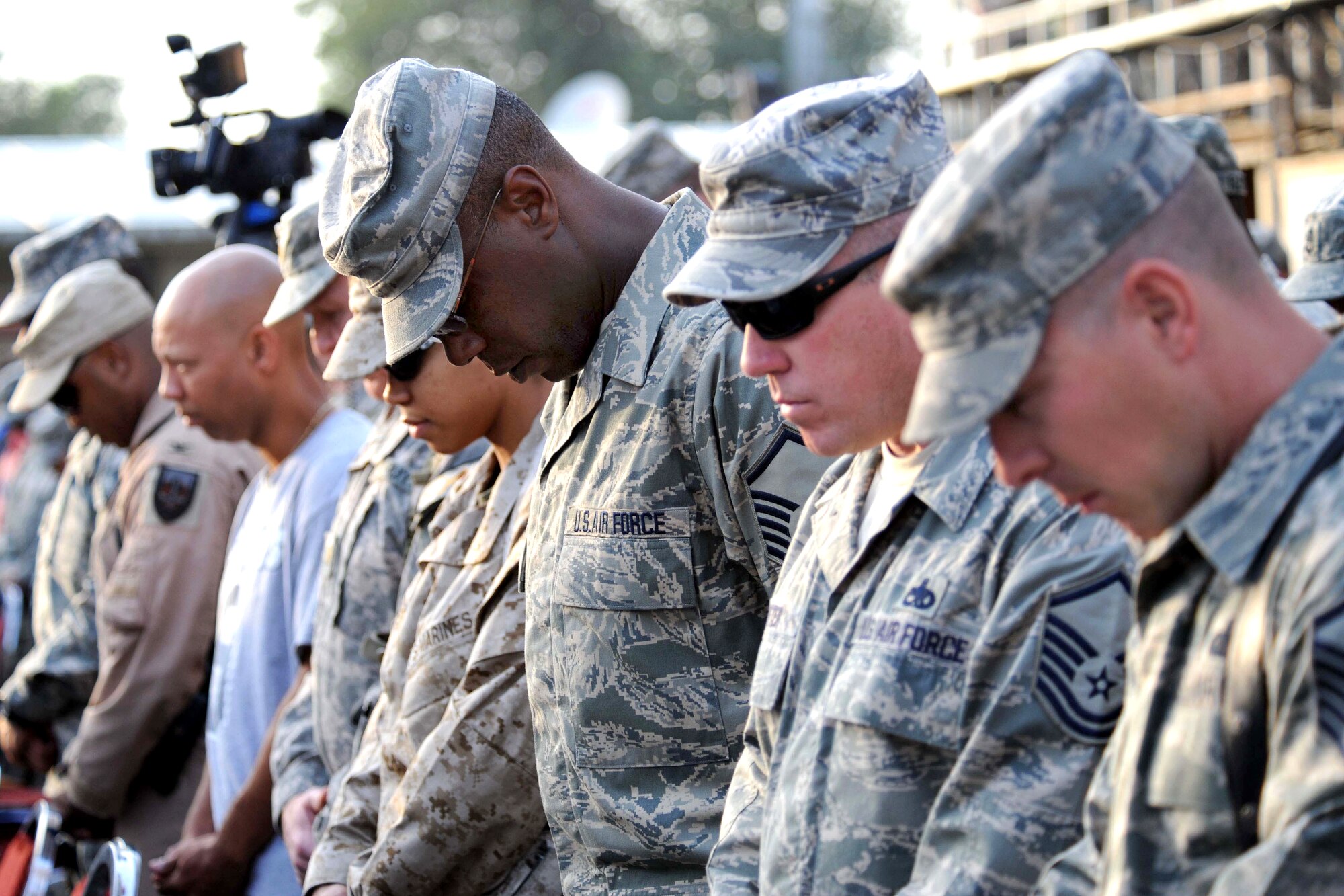 CAMP EGGERS, Afghanistan - Service members from all branches of the U.S. Armed Forces assigned to the Combined Security Transition Command - Afghanistan, pay their respects during a 2009 9/11 remembrance ceremony. Various 9/11 remembrance events are scheduled in the area for people to attend. Department of Defense photo
