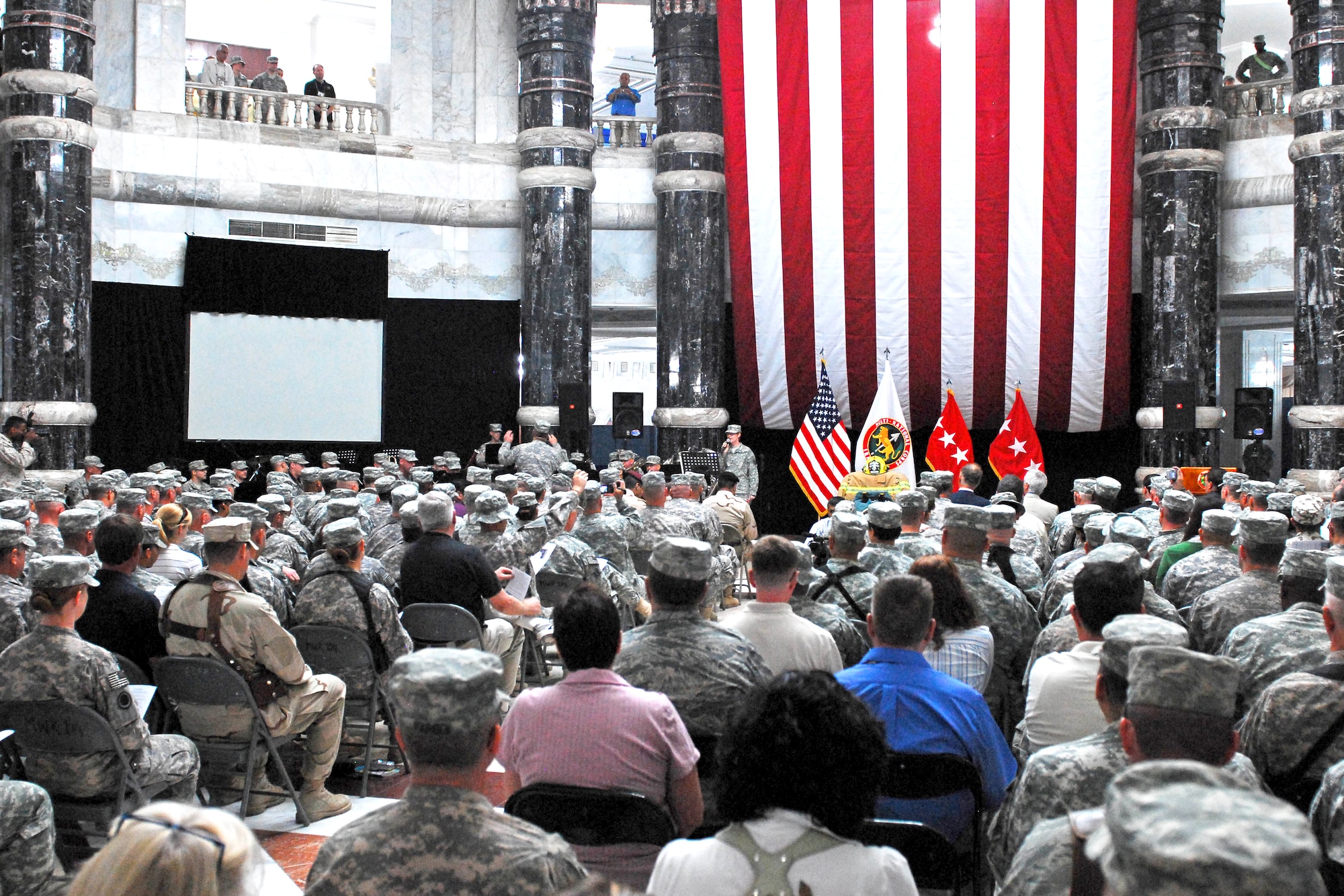 Service members and civilians gather to honor the fallen from the Sept. 11 attacks during a 9/11 remembrance ceremony held Sept. 11, 2009, at the Al Faw Palace, Camp Victory, Baghdad.