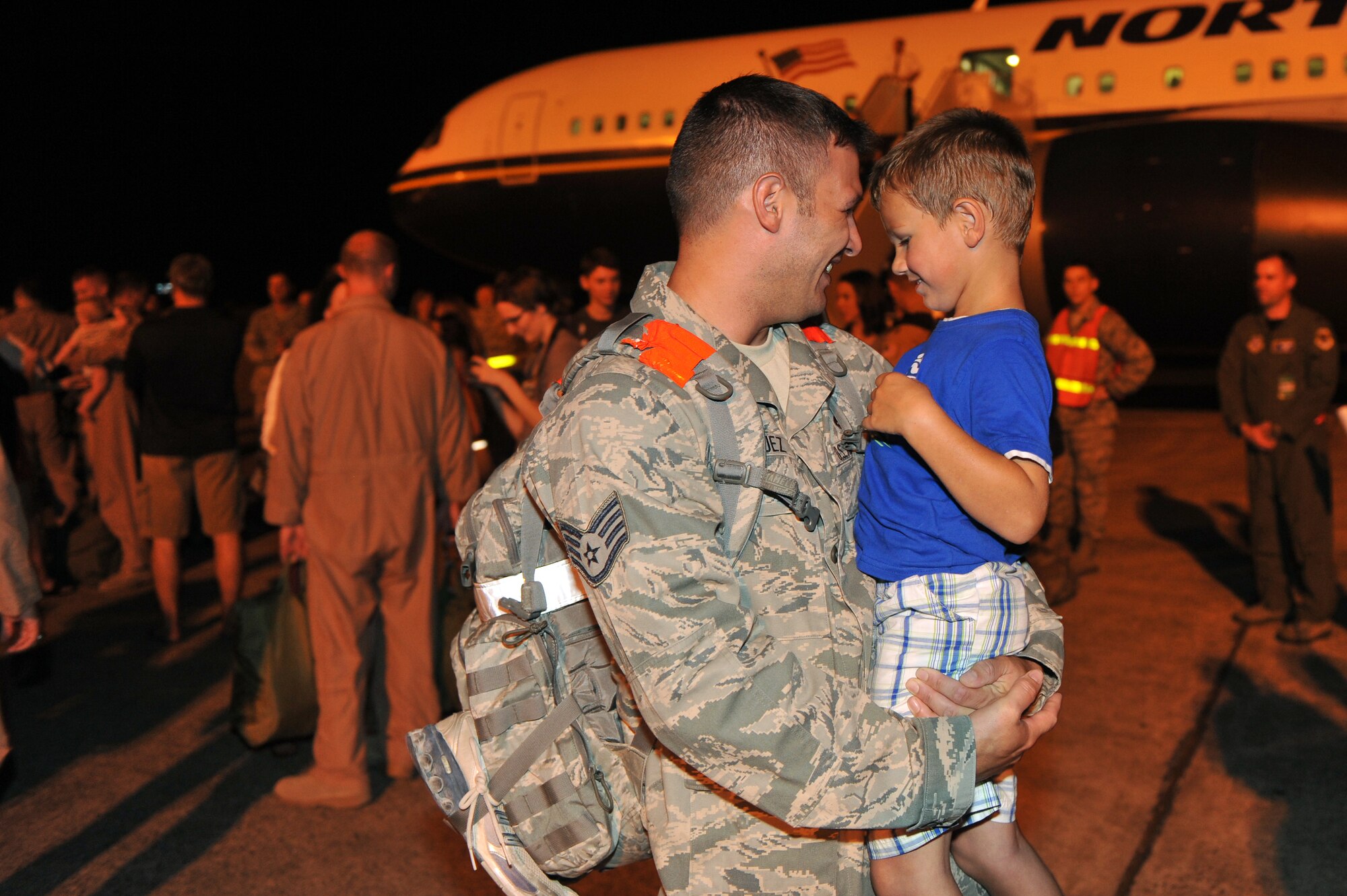 Staff Sgt. Francisco Velasquez, 19th Equipment Maintenance Squadron aircraft structural maintenance craftsman, shares a moment with his son, Aden, on the base flightline Sept. 1.  Sergeant Velasquez returned from a four-month deployment at Joint Base Balad, Iraq.  (U.S. Air Force photo by Staff Sgt. Chris Willis)