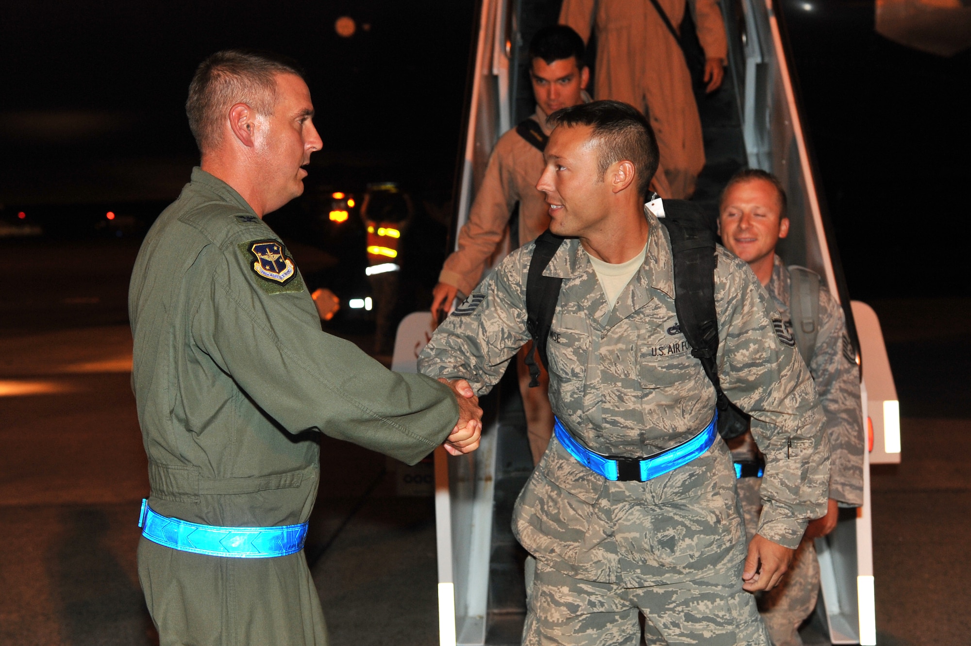 Col. Michael Minihan, 19th Airlift Wing commander, greets Tech. Sgt. Lucas Wise, 19th Maintenance Operations Squadron quality assurance, and other military members as they exit a rotator aircraft Sept. 1.  Base leaders, friends and families welcomed home more than 160 Airmen returning from deployments in Southwest Asia.  (U.S. Air Force photo by Staff Sgt. Chris Willis)