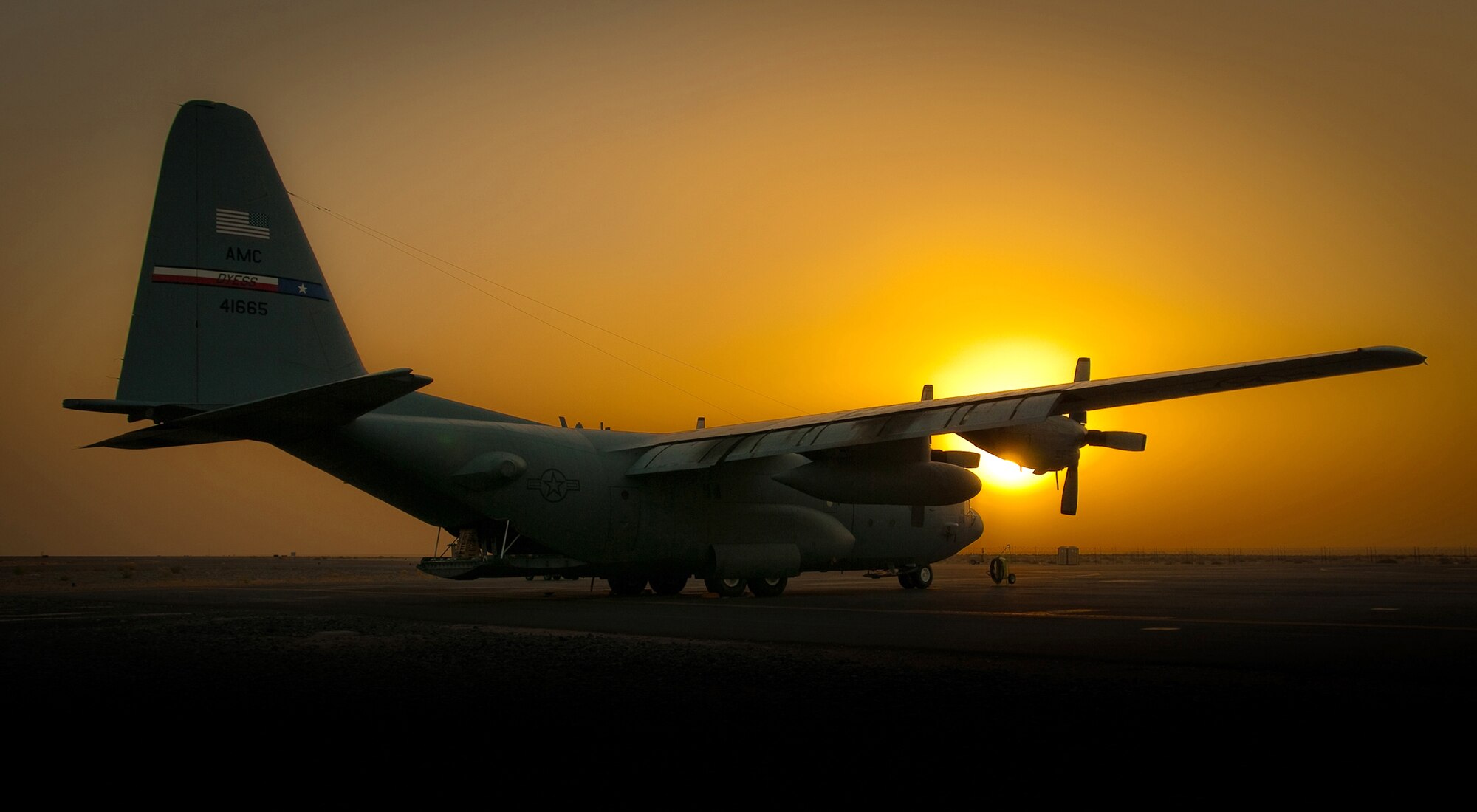 The sun sets on a C-130 Hercules Aug. 31, 2010, as Operation Iraqi Freedom draws to a close at an air base in Southwest Asia.  Operation New Dawn began Sept. 1, bringing with it a new mission focused on a strategic partnership signifying the U.S. government's long-term commitment to the government and people of Iraq. (U.S. Air Force photo/Maj. Dale Greer)
