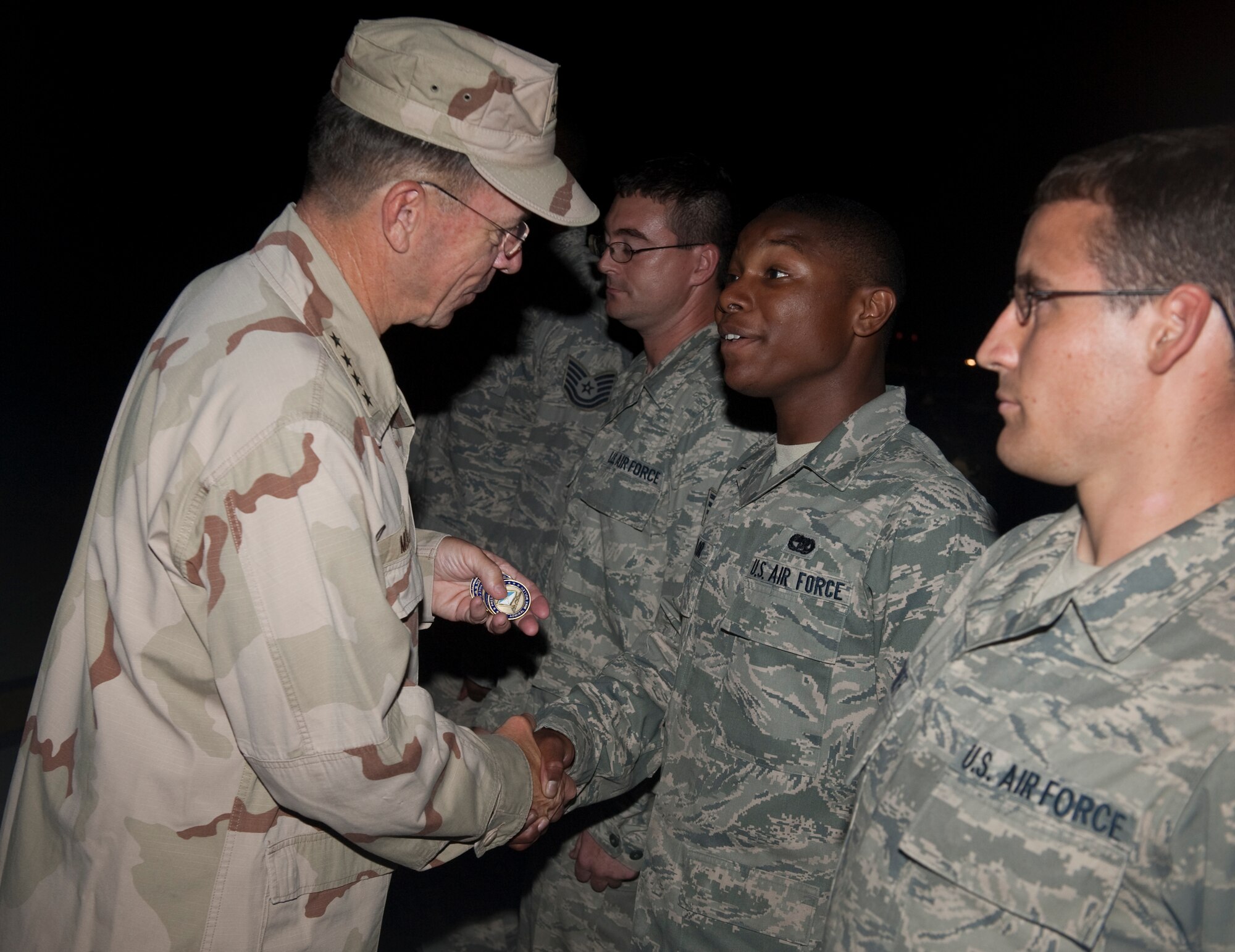 Navy Adm. Mike Mullen, chairman of the Joint Chiefs of Staff coined Airmen from the 621st Contingency Response Wing during a visit to Islamabad, Pakistan on Sept. 1, 2010. The 40 Airmen from the 621 CRW are at Chaklala Air Force Base, Pakistan, providing additional manpower, equipment and organization to current flood relief operations out of Pakistan’s Flood Relief Cell. (DoD Photo by Mass Communication Specialist 1st Class Chad J. McNeeley/Released)
