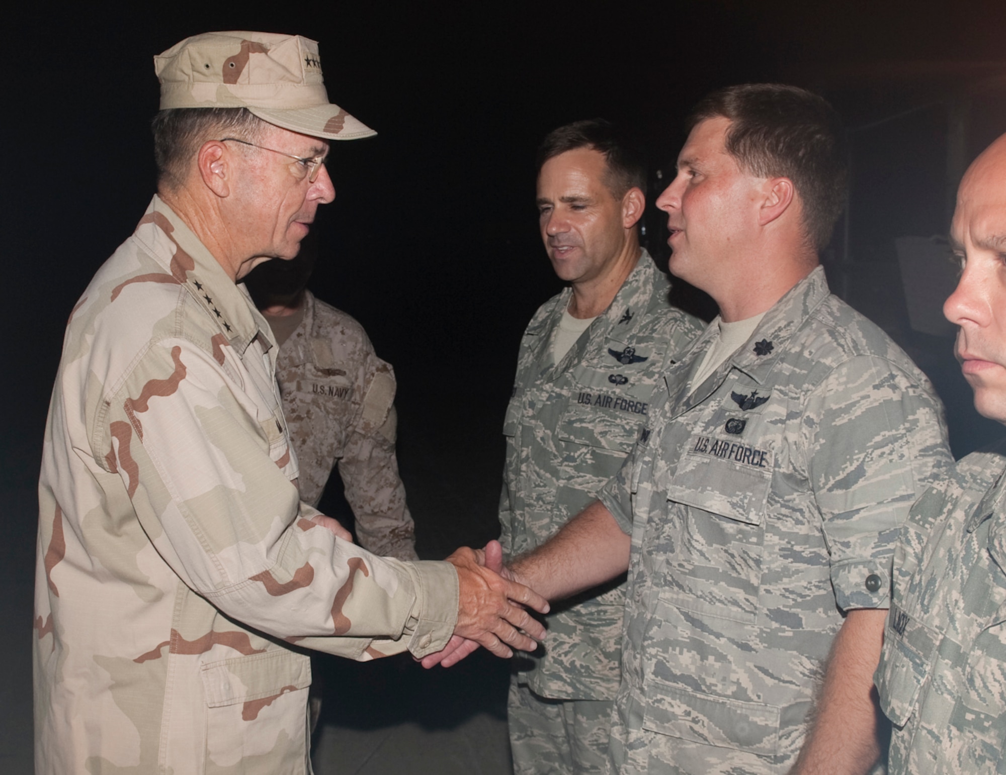 Navy Adm. Mike Mullen, chairman of the Joint Chiefs of Staff coined Lt. Col. Shawn Underwood, 621st Contingency Response Element commander, during a visit to Islamabad, Pakistan on Sept. 1, 2010. The 40 Airmen from the 621 CRE are at Chaklala Air Force Base, Pakistan, providing additional manpower, equipment and organization to current flood relief operations out of Pakistan’s Flood Relief Cell. (DoD Photo by Mass Communication Specialist 1st Class Chad J. McNeeley/Released)