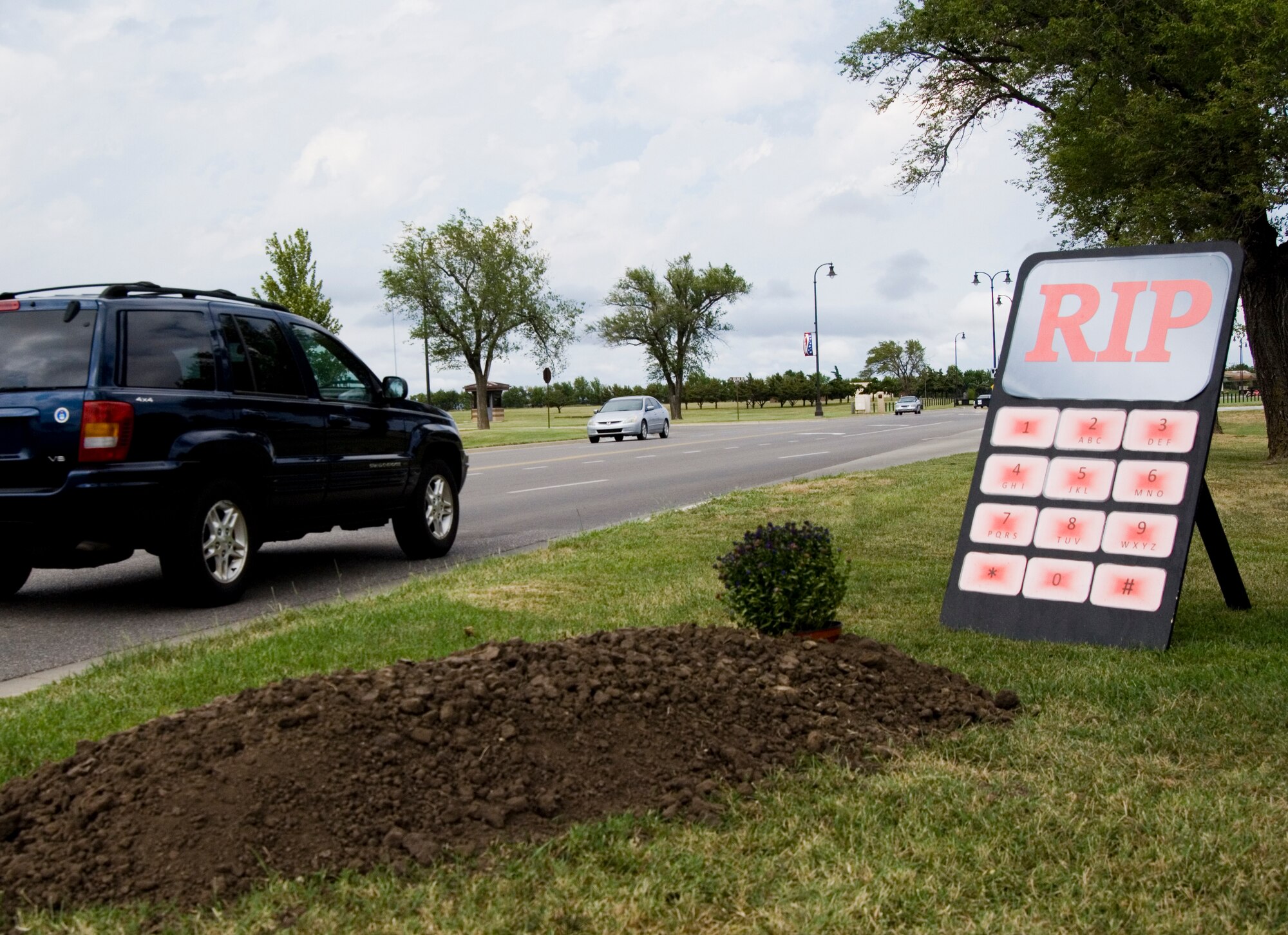McConnell members pass a sign by the 22nd Air Refueling Wing Ground Safety office that promotes “responsible texting,” Sept. 1, 2010, McConnell Air Force Base, Kan.  The displays, which include four sets of signs measuring five feet tall, are modeled after cell phone key pads and will be featured until Labor Day weekend concludes.  (U.S. Air Force photo/Senior Airman Abigail Klein)