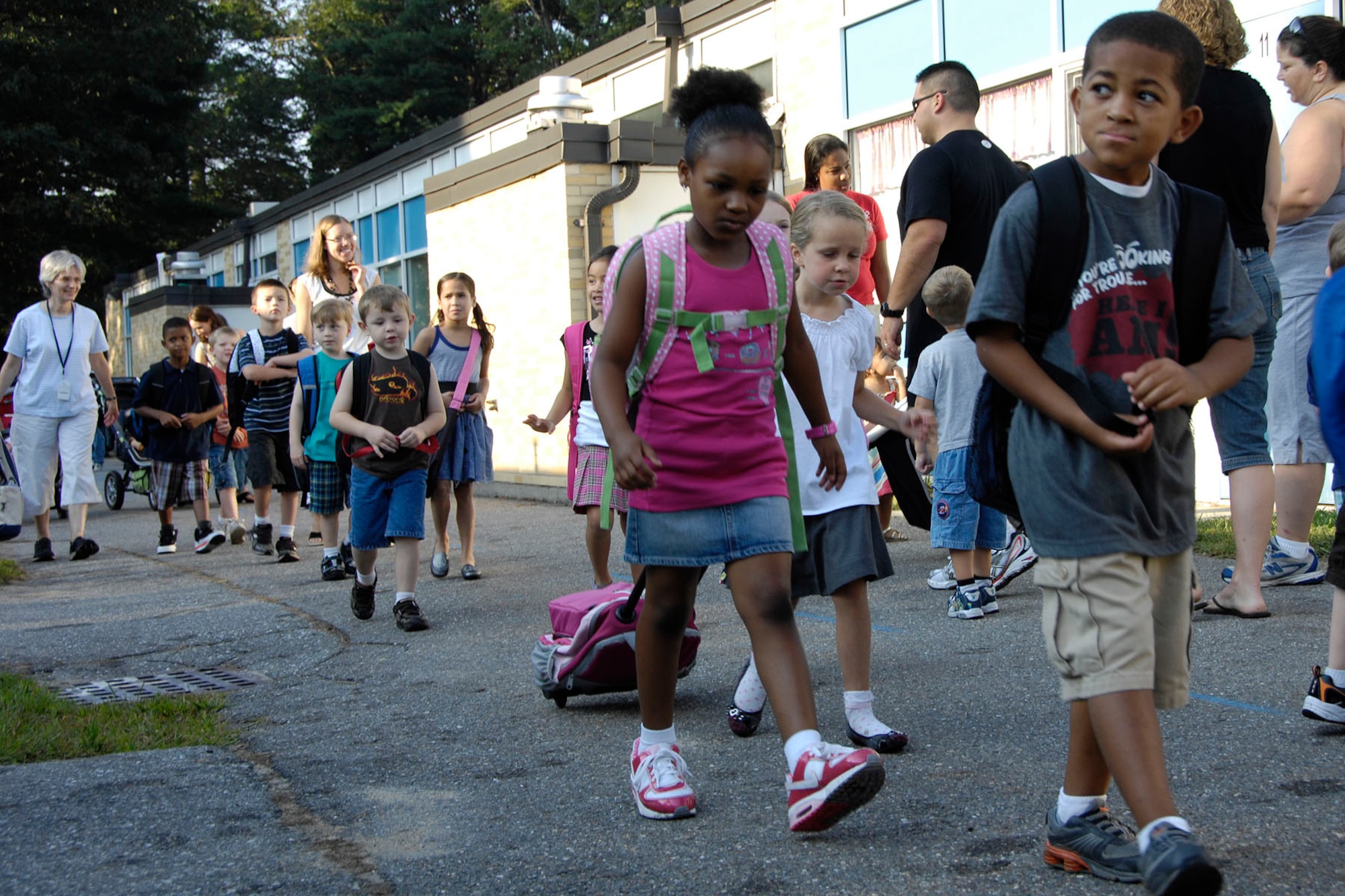 HANSCOM AIR FORCE BASE, Mass. – Decked out with new clothes, shoes and school supplies, students walk to school on Sept. 1. Wednesday marked the first day of classes for students enrolled at Hanscom Primary and Hanscom Middle schools. (U.S. Air Force photo by Linda LaBonte Britt)