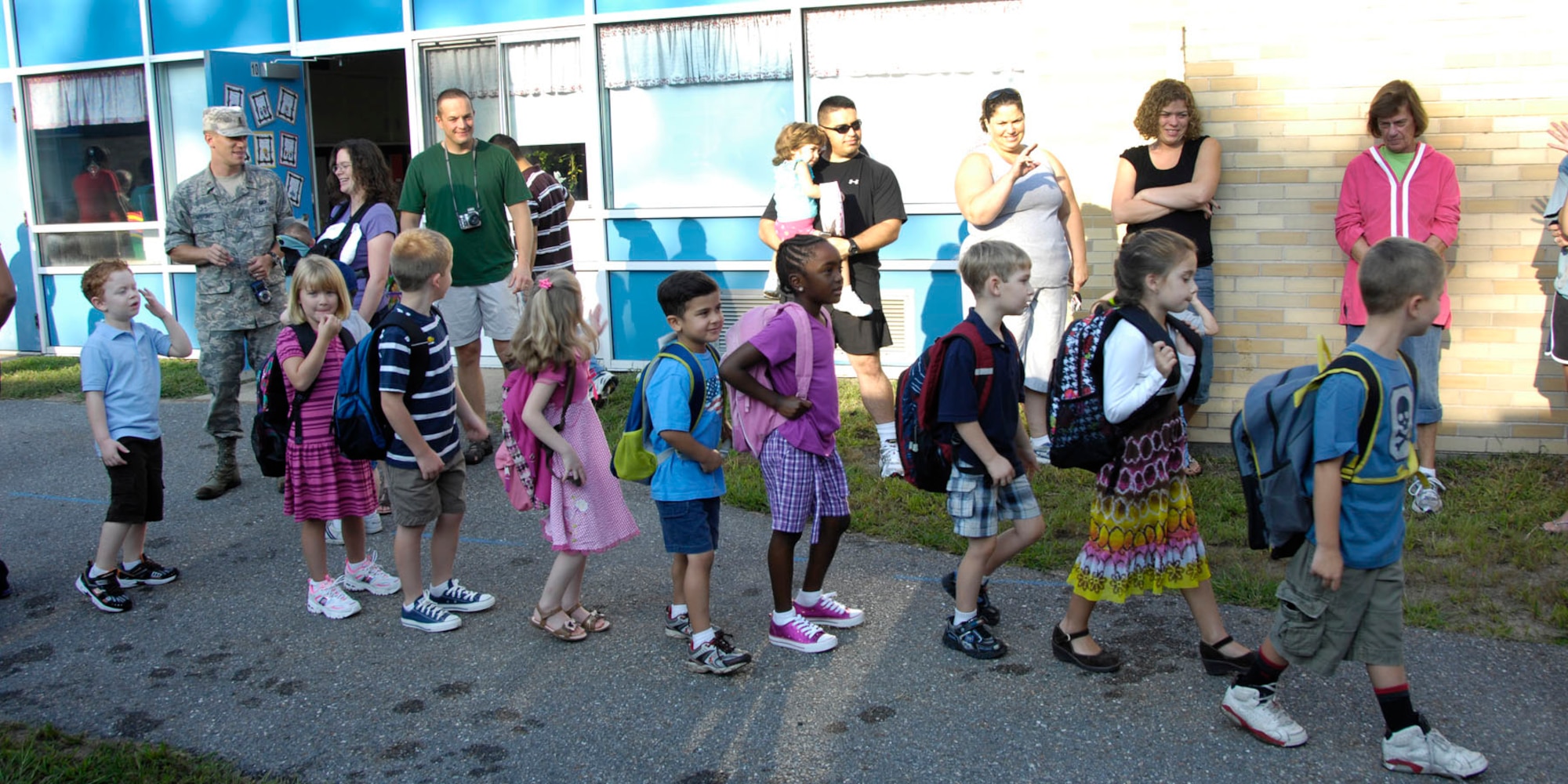 HANSCOM AIR FORCE BASE, Mass. – Students march toward school as parents wave goodbye. Base personnel may notice more children crossing the street and school buses driving up and down the road because Sept. 1 marked the first day of classes at Hanscom Primary and Hanscom Middle schools. (U.S. Air Force photo by Linda LaBonte Britt)