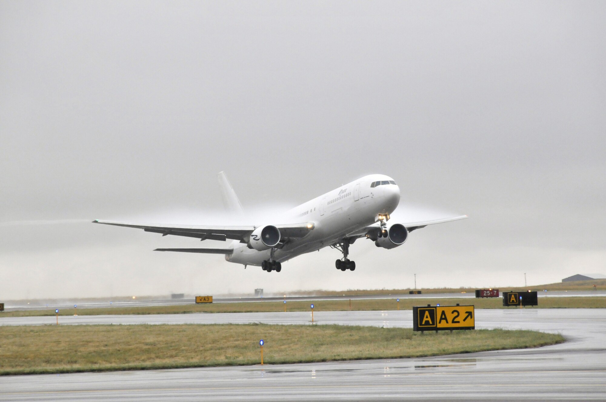 A charter flight carrying more than 200 members of the 819th and 219th RED HORSE Squadrons departs Great Falls International Airport Aug. 30. The group was headed for Fort McCoy, Wis., for pre-deployment training. (U.S. Air Force photo/John Turner)