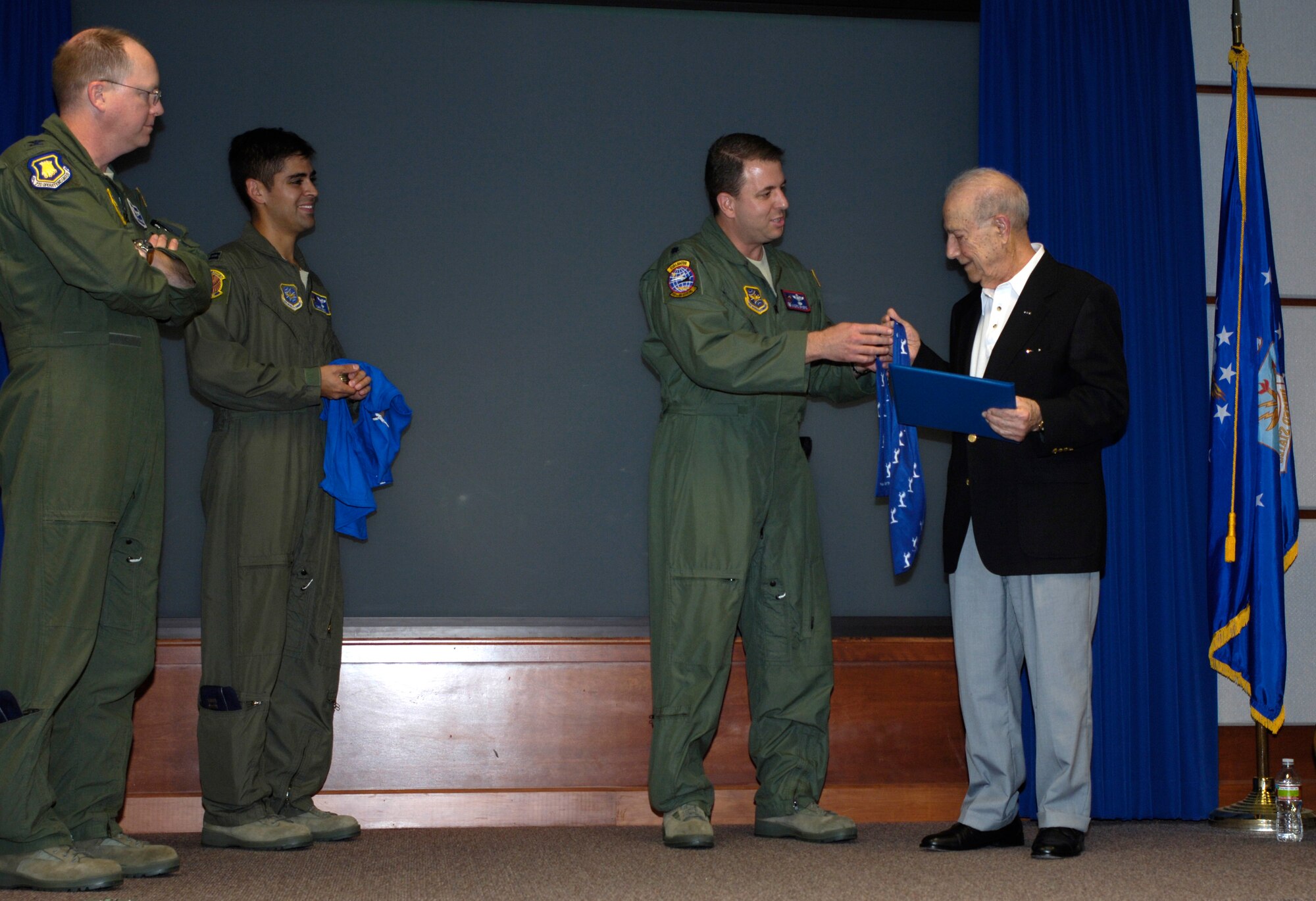 Lt. Col. André Briere, 349th Air Refueling Squadron commander, presents a bandit scarf to Richard R. Ayesh, a retired first lieutenant from the 349th Bomb Squadron, Aug. 27, 2010. Mr. Ayesh spoke to 349th ARS Airmen about his experiences with the 349th BS during World War II. Following his talk, the squadron made Mr. Ayesh and honorary bandit. (U.S. Air Force photo/ Airman 1st Class Armando A. Schwier-Morales) 