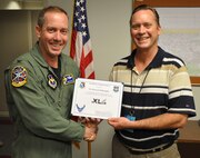 LAUGHLIN AIR FORCE BASE, Texas – Howard Willoughby, 47th Civil Engineering Squadron, is presented the XLer of the Week award by Col. Michael Frankel, 47th Flying Training Wing commander, Sept. 1. The XLer is a weekly award chosen by 47th FTW leadership and given to individuals who consistently make outstanding contributions to Laughlin and their unit. (U.S. Air Force photo by Airman 1st Class Blake Mize)
