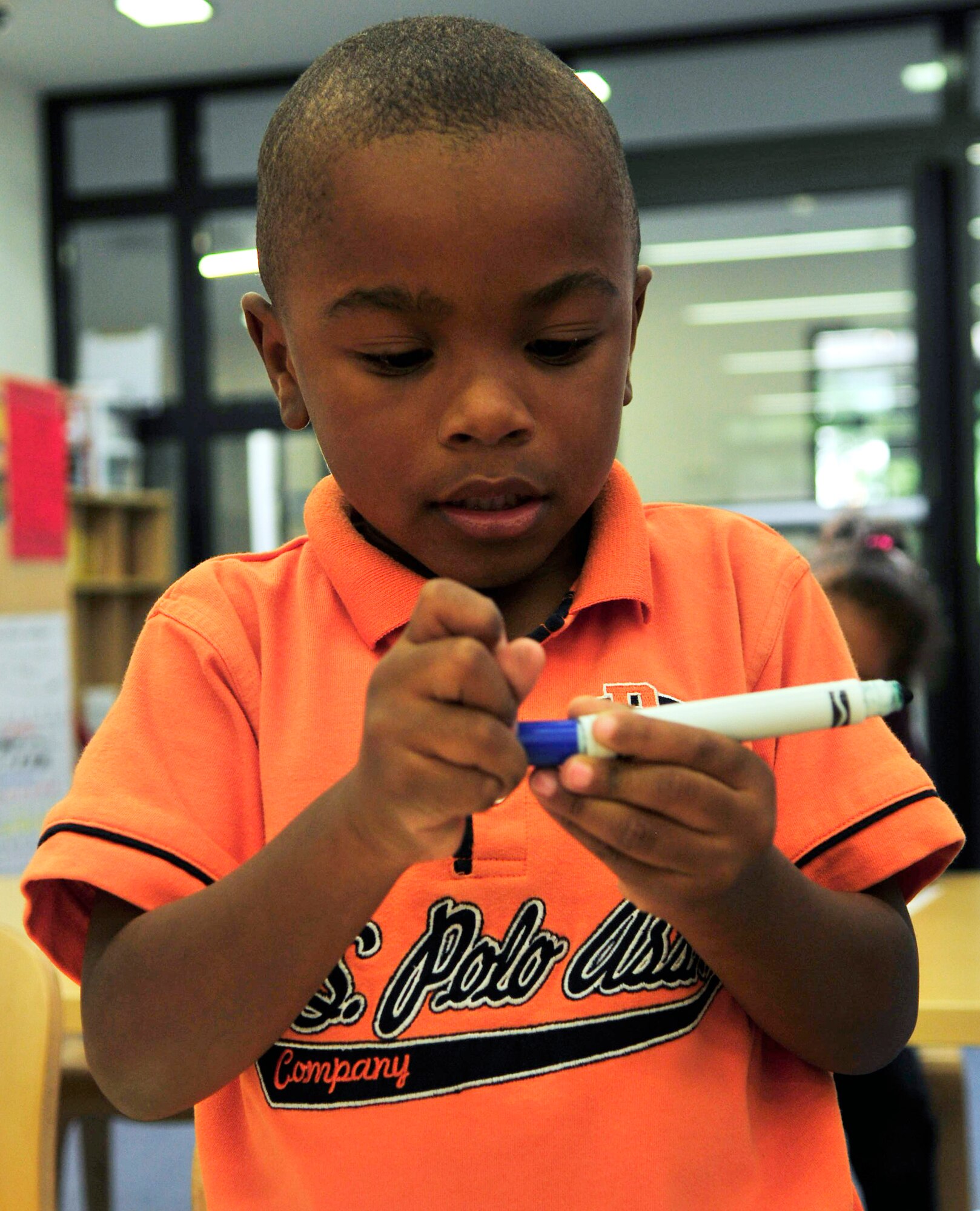 Justin Miller, son of Enecia and Cliftin Miller, Defense Logistics Agency, prepares to draw a picture at the new Child Development Center, Ramstein Air Base, Germany, Sept. 1, 2010. (U.S. Air Force photo by Senior Airman Amanda Dick)
