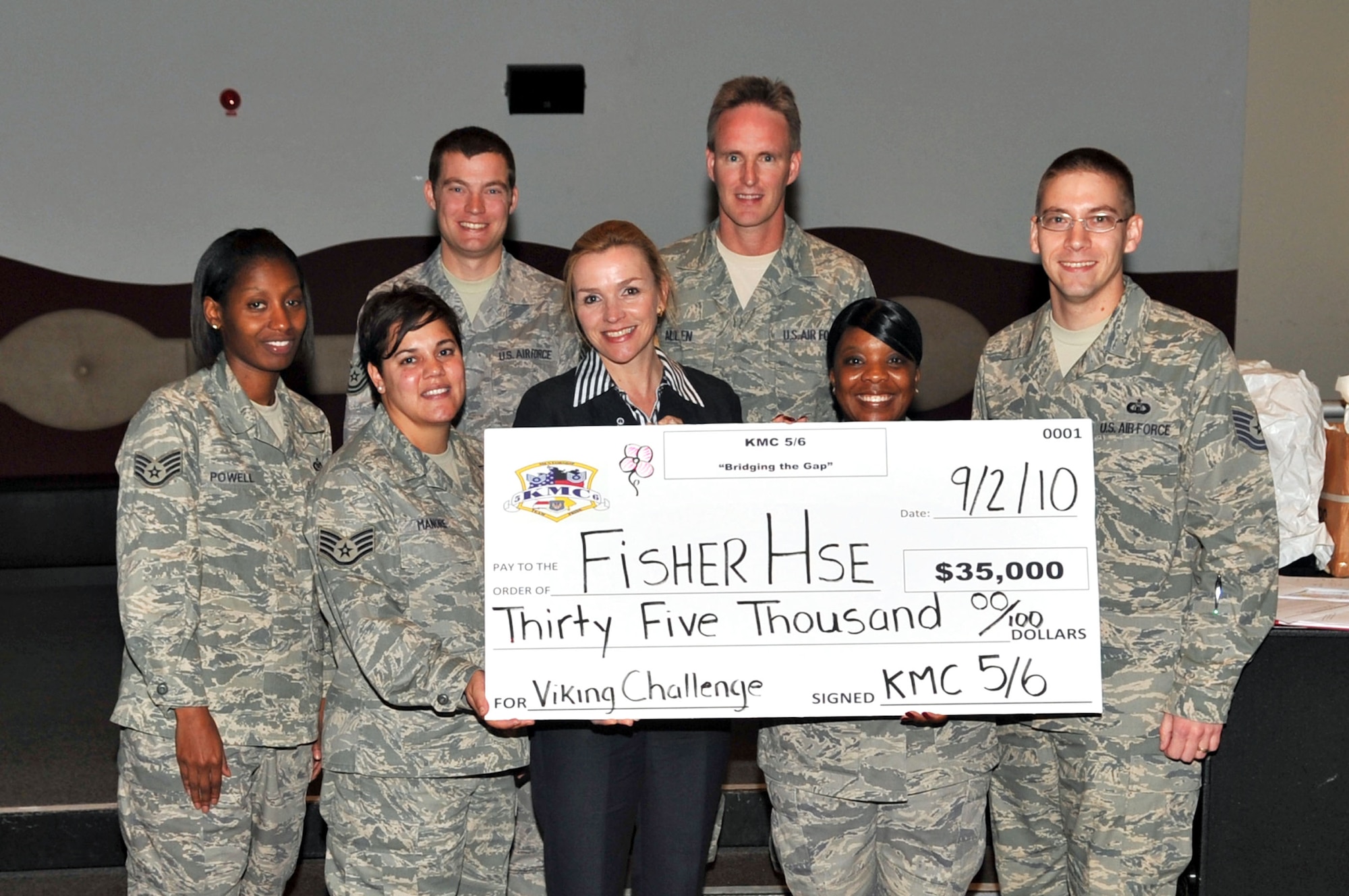 Kaiserslatern Military Commuinty (KMC) 5/6 Club presents a check to Vivian Wilson, manager of the Fisher House, Landstuhl Regional Medical Center, Ramstein Air Base, Germany, Sept. 2, 2010. The Fisher House is one of the organizations that the 5/6 helps directly with fundraisers, meal drop off's and spending time with the guests. The mission of the 5/6 is  to equip NCOs with career enhancement tools for increased knowledge of accountability, discipline and standards through leadership by example. (U.S. Air Force photo by Airman 1st Class Desiree Esposito)