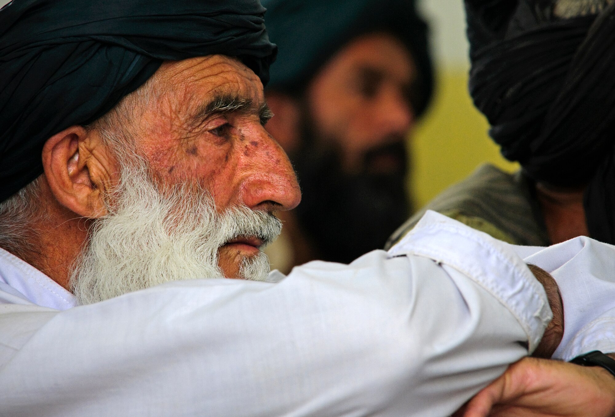 COMBAT OUTPOST MIZAN, Afghanistan - A local Afghan elder listens as Mizan District Chief Noor Mohammed speaks during a shura at the Mizan District Center, Mizan District, Zabul province, Aug. 28. Mizan District officials invited local elders to the shura to discuss the upcoming provincial parliamentary elections and encourage residents to vote. (U.S. Air Force Photo/Senior Airman Nathanael Callon/Released)
