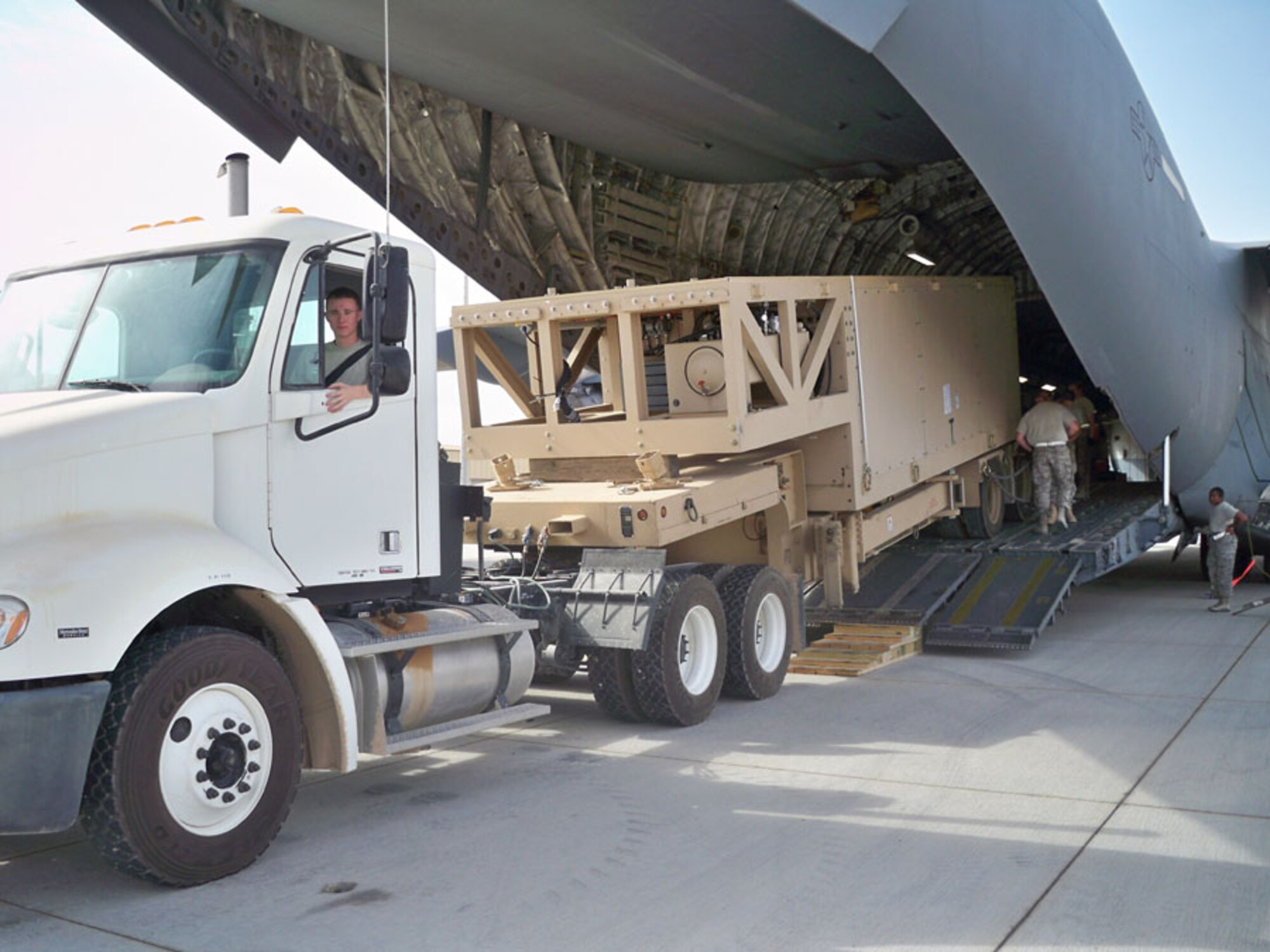 Airman 1st Class Malcolm Macdonald, deployed to Southwest Asia from the 18th Logitistics Readiness Squadron, offloads equipment from a C-17 at his deployed location. (U.S. Air Force photo)