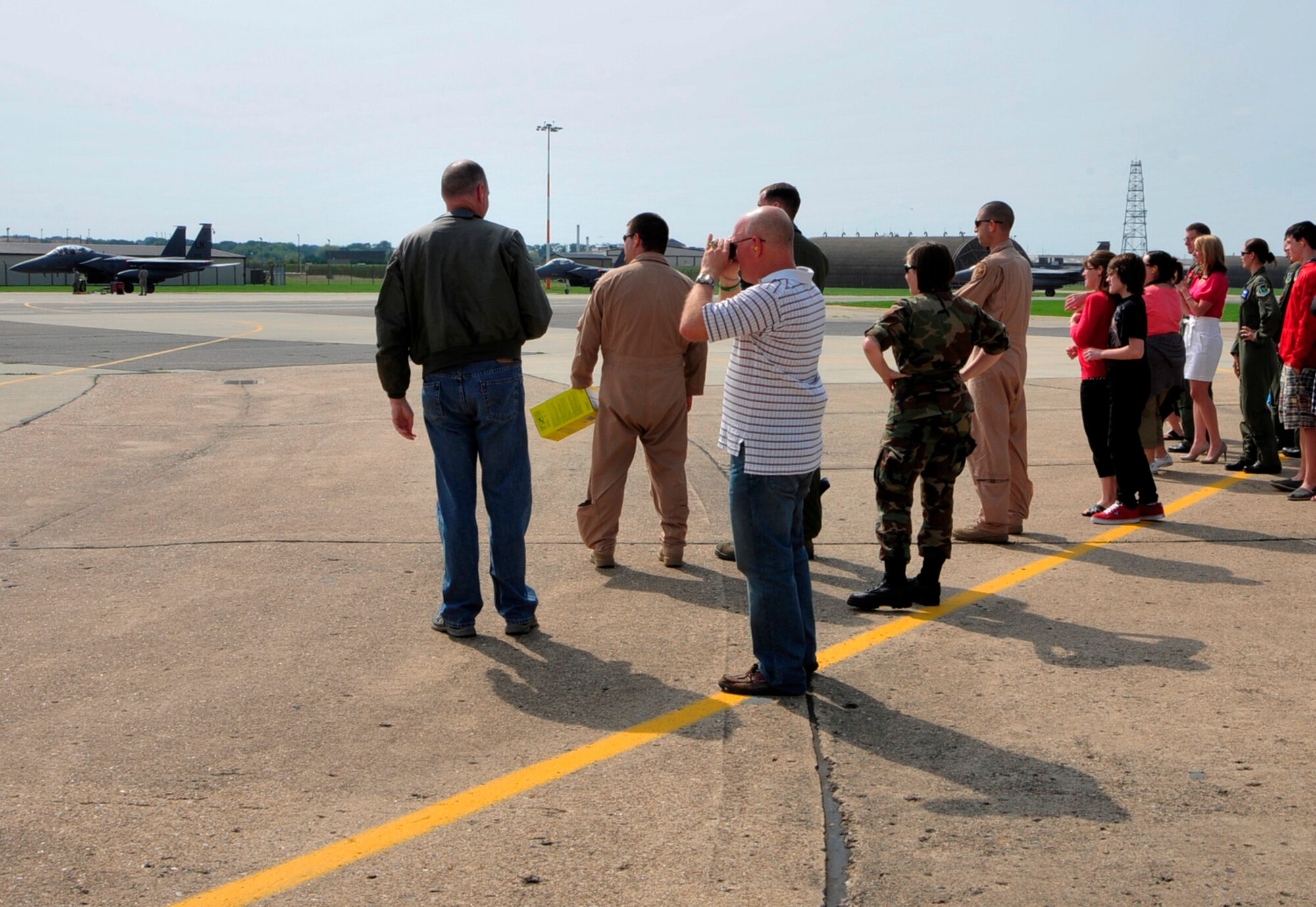 Family and friends gather at the flightline on RAF Lakenheath, England, to welcome back 492nd Fighter Squadron pilots Sept. 1, 2010. The pilots were returning from a four-month deployment to Bagram, Afghanistan. (U.S. Air Force photo/Airman 1st Class Tiffany Deuel)