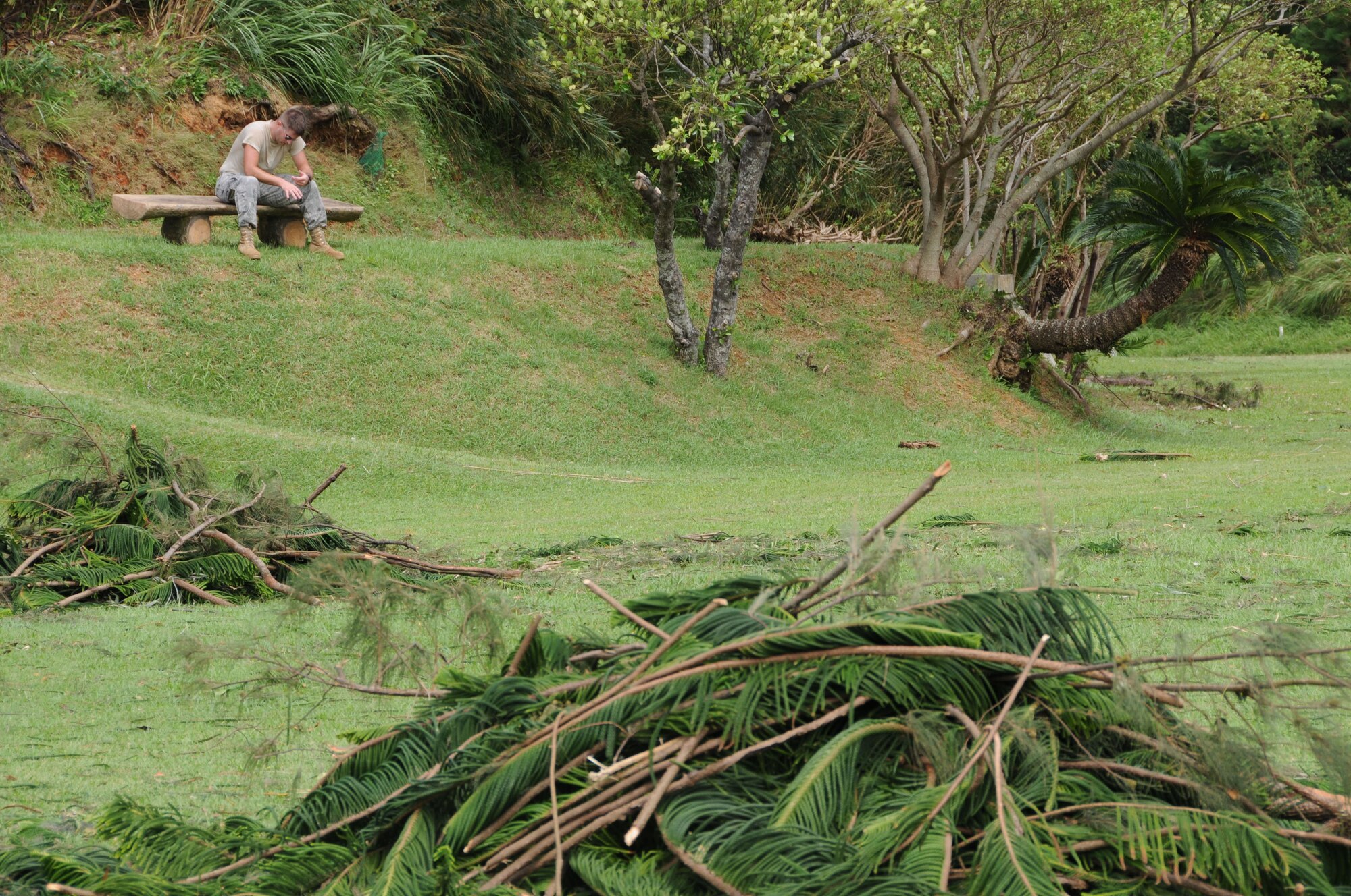 An Airman from the 18th Wing takes a break during the Okuma Recreation Area clean-up , Sep. 2, 2010. More than 100 Airmen from Kadena Air Base volunteered to help clean up the debris caused by Typhoon Kompasu. (U.S. Air Force photo/Staff Sgt. Darnell T. Cannady)