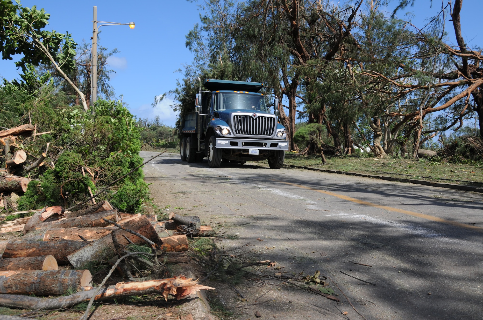 A truck transporting debris caused by Typhoon Kompasu leaves the Okuma Recreation Area, Sep. 2, 2010. More than 100 Airmen from Kadena Air Base volunteered to help clean up the debris. (U.S. Air Force photo/Staff Sgt. Darnell T. Cannady)