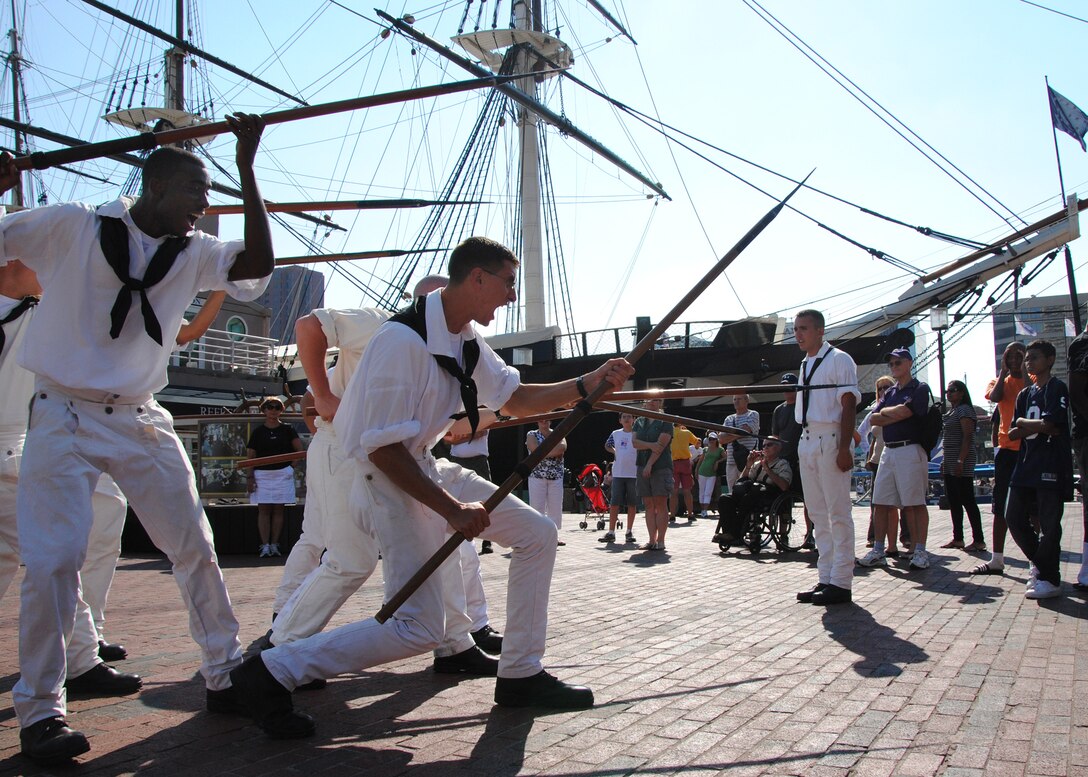 Sailors assigned to Boston-berthed USS Constitution demonstrate boarding pike drills in Baltimore’s Inner Harbor on Aug. 28, 2010, as part of Navy Week. Some of the Constitution’s crew also prepared and served hot meals to people at a Baltimore homeless shelter on Aug. 30, 2010.  U.S. Navy photo by Seaman Shannon S. Heavin