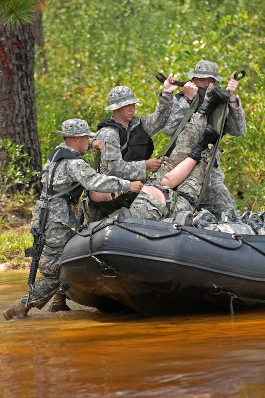 U.S. Army soldiers place a simulated casualty in their zodiac boat for extraction from the beach at Mott Lake during their waterborne operations training on Fort Bragg, N.C., Aug. 26, 2010. The soldiers are assigned to Company F, 2nd Battalion, 82nd Combat Aviation Brigade. 
