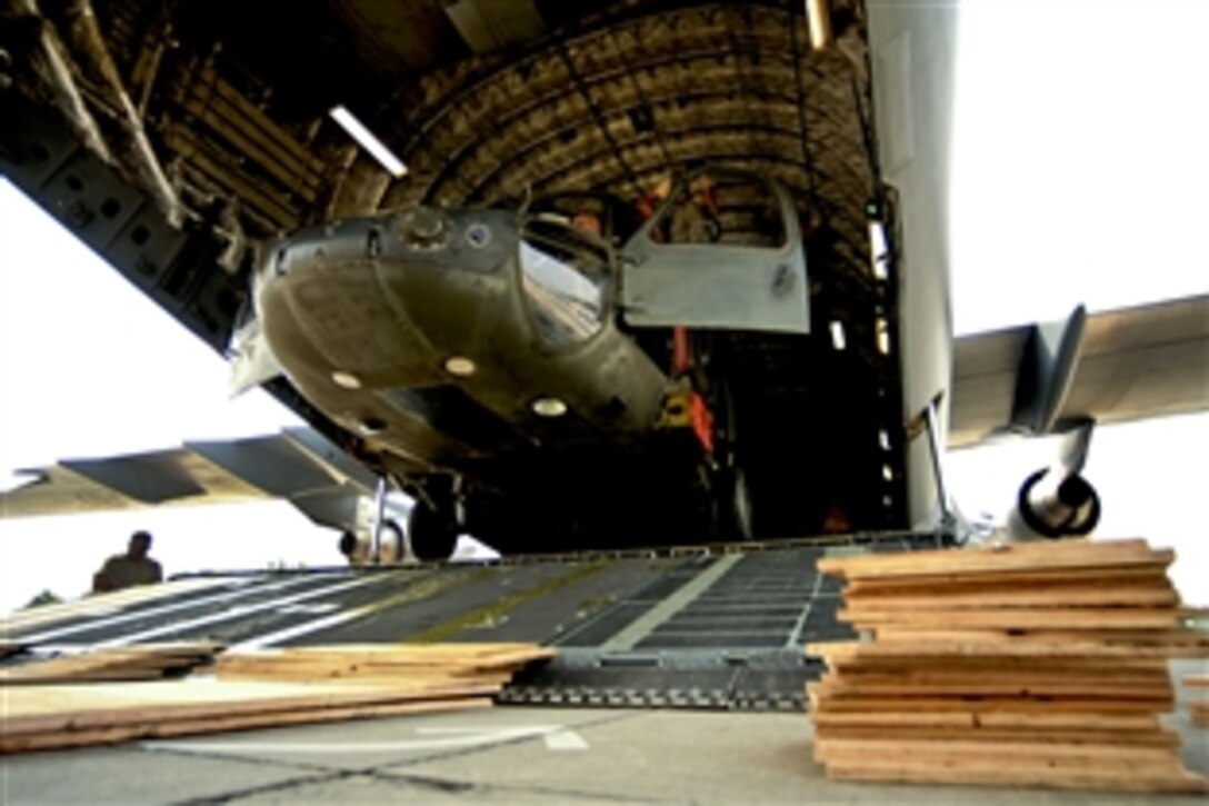 U.S. Air Force airmen and U.S Army soldiers remove straps from UH-60 Black Hawk helicopters and cargo aboard a C-17 Globemaster III aircraft on Chaklala Air Force Base, Pakistan, Sept. 1, 2010. The airmen are assigned to the the 818th Contingency Response Element and the soldiers are assigned to the 16th Combat Aviation Brigade. Troops will fly supplies throughout Pakistan to aid flood victims.
