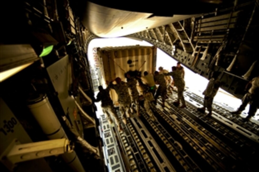 U.S. Air Force airmen unload cargo from a C-17 Globemaster III aircraft on Chaklala Air Force Base, Pakistan, Sept. 1, 2010. The airmen are assigned to the 818th Contingency Response Element and the soldiers are assigned to the 16th Combat Aviation Brigade. Troops will transport supplies throughout Pakistan to aid flood victims.