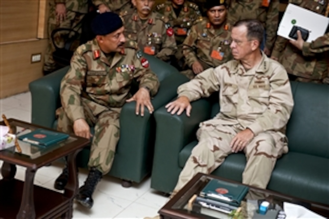 U.S. Navy Adm. Mike Mullen, chairman of the Joint Chiefs of Staff, speaks with Pakistani Army Lt. Gen. Ahmed Shafqaat in Multan, Pakistan, Sept. 2, 2010. Mullen toured regions of the country devastated by floods with Pakistani military leaders.
