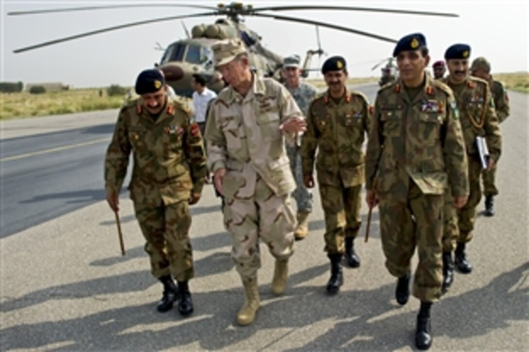 U.S. Navy Adm. Mike Mullen, chairman of the Joint Chiefs of Staff, speaks with Pakistani Army Lt. Gen. Ahmed Shafqaat and Gen. Parvez Kayani, chief of Army Staff, in Multan, Pakistan, Sept. 2, 2010, after returning from an aerial tour of the Pakistani regions devastated by floods.