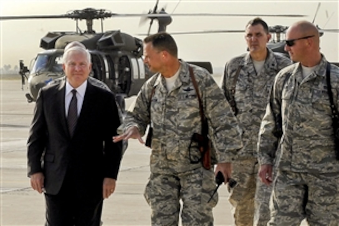 U.S. Defense Secretary Robert M. Gates walks down the flightline of Baghdad International Airport after departing Camp Victory, Iraq, en route to Kabul, Afghanistan, Sept. 2, 2010.