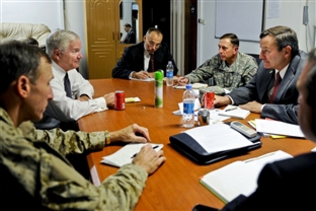U.S. Defense Secretary Robert M. Gates, rear left, talks with U.S. Ambassador to Afghanistan Karl. W. Eikenberry, right, and U.S. Army Gen. David H. Petraeus, commander of the International Security Assistance Force, right rear, during a meeting on Camp Eggers, Afghanistan, Sept. 2, 2010.  