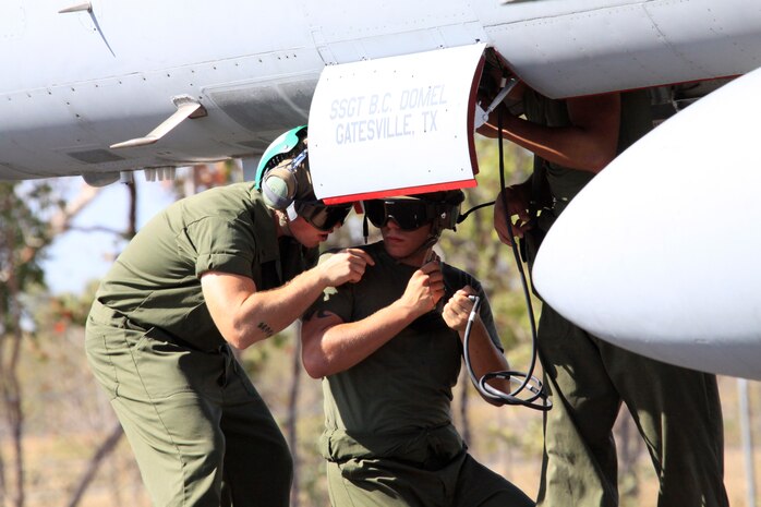 Lance Cpl. Kieth Shirley and Lance Cpl. Jesse Kyer, Marine All-Weather Fighter Attack Squadron 224 aircraft communication and navigation technicians, perform an electrical and fluids check during a prior to a familiarization flight here Sept. 2. VMFA(AW)-224 maintainers have to check to make sure the jets maintain enough hydrolic fluid for flight control systems to function properly.