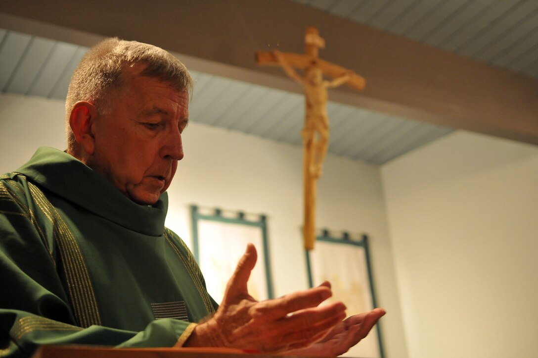 Lt. James Finley, Catholic chaplain for the Marine Corps Air Station in Yuma, Ariz., reads from the Bible during a Catholic Mass at the station chapel Sept. 2, 2010. The 73-year-old New York City-native is the oldest sailor in the service, with 47 years in the priesthood, 20 of it as a Navy chaplain.