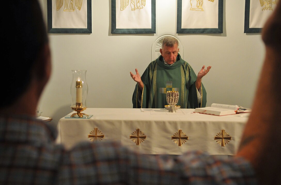 Lt. James Finley, Catholic chaplain for the Marine Corps Air Station in Yuma, Ariz., prays during a Catholic Mass at the station chapel Sept. 2, 2010. The 73-year-old New York City-native is the oldest sailor in the service, with 47 years in the priesthood, 20 of it as a Navy chaplain.