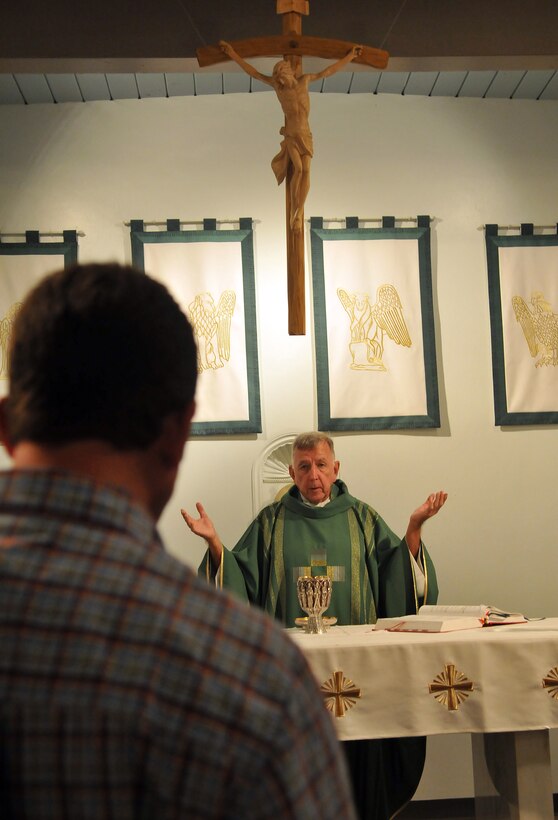 Lt. James Finley, Catholic chaplain for the Marine Corps Air Station in Yuma, Ariz., prays during a Catholic Mass at the station chapel Sept. 2, 2010. The 73-year-old New York City-native is the oldest sailor in the service, with 47 years in the priesthood, 20 of it as a Navy chaplain.