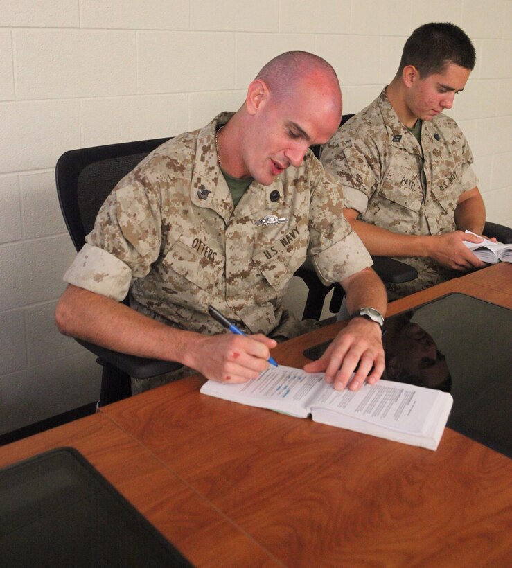 Petty Officer 2nd Class Norman Otters, a religious program specialist enrolled in the Chaplain and Religious Program Specialist Expeditionary Skills Training course, studies Marine Corps knowledge during a common skills class aboard Camp Johnson, recently.  CREST hones the sailors’ combat skills and immerses them in the Marine Corps lifestyle so they will be better prepared to protect their chaplains, Marines and fellow sailors in combat.