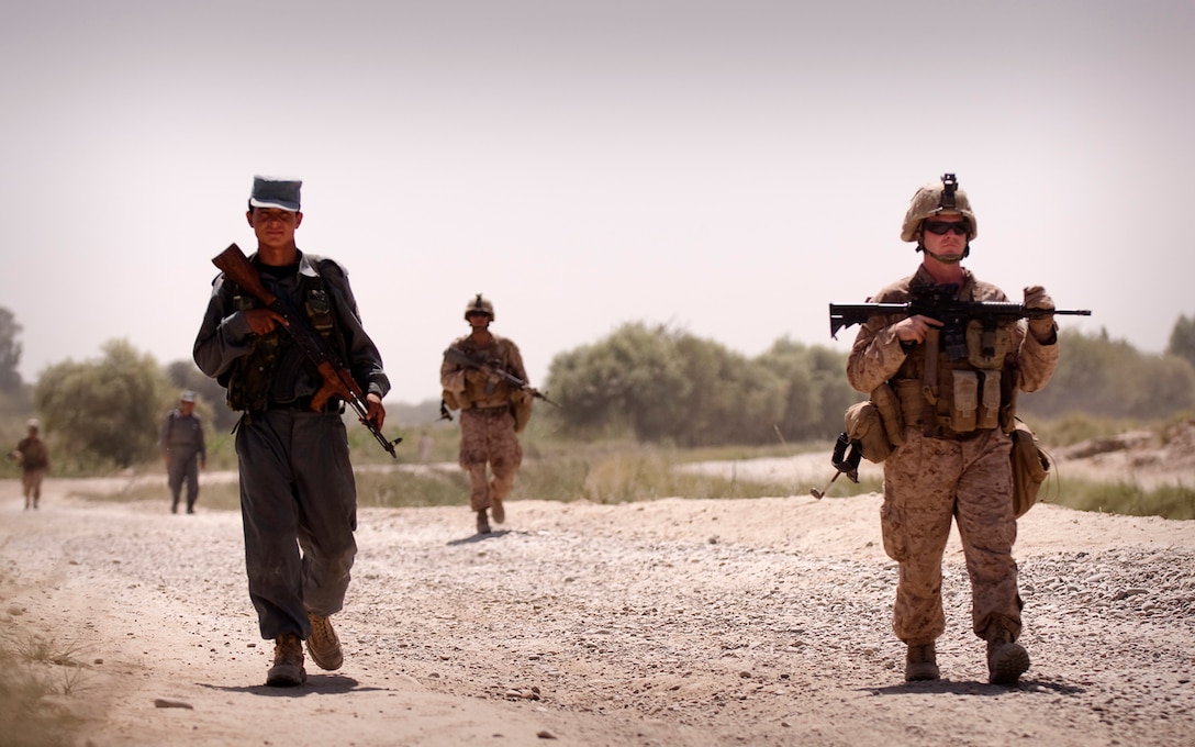 Sgt. Christopher Conaway, a squad leader with Kilo Company, 3rd Battalion, 3rd Marine Regiment, leads his squad and Afghan National Police officer partners on a brief patrol back to Patrol Base Jaker after manning a vehicle checkpoint as part of security for the Nawa District bazaar in Helmand province, Afghanistan, Sept. 3, 2010. The Marines supervise and provide additional security during the checkpoint. Afghanistan National Police officers perform most of the checkpoint duties. Conaway is from Marshall, Mo.