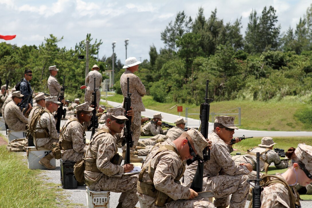 Range Coaches watch the line during the 300 yard live fire on qualification day, Sept. 3.