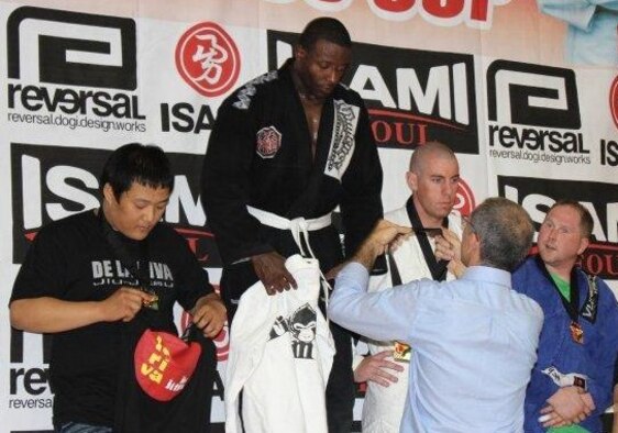taff Sgt. Duriel Howard, 8th Security Forces Squadron standardization and evaluation NCO, receives one of two gold medals he received recently at the fifth annual De La Riva BJJ (Brazilian Jiu-jitsu)Cup in Seoul, Korea. (U.S. Air Force photo/courtesy photo) 