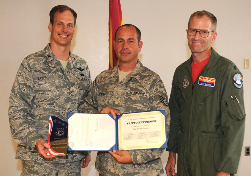 (From the left) Col. Jim Taylor, 162nd Maintenance Group commander, Staff Sgt. Joseph Espinosa, an aircraft maintainer from Operation Snowbird, and Lt. Col. Jeff Butler, Operation Snowbird commander, commemorate Sergeant Espinosa's Elite Performer Award at Tucson International Airport Sept. 3. (Air Force photo by Maj. Gabe Johnson)