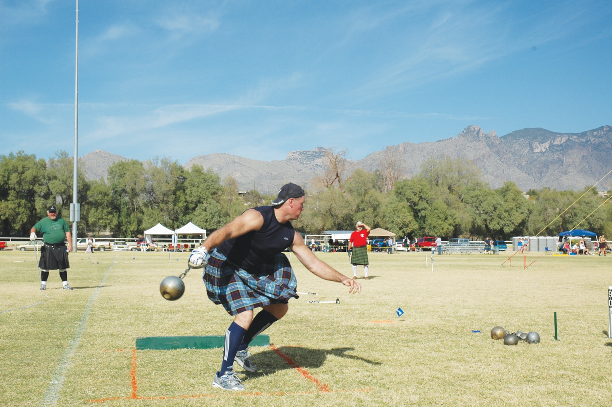 Maj. Shawn Baker, 56th Medical Group orthopedics, swings a hammer as part of a Scottish Masters Athletics International Competition even in Denver, Colorado.  Baker has been competing in the games for four years. (Courtesy photo)