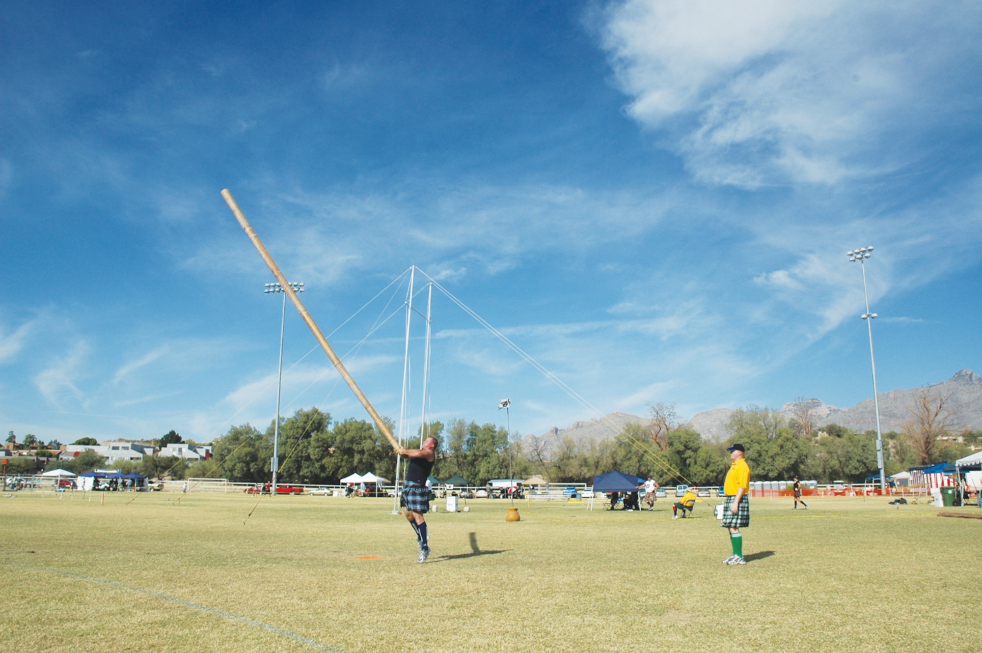 Maj. Shawn Baker, 56th Medical Group orthopedics, tosses a caber during a Scottish Masters Athletics International Competition event in Denver.  The caber is like a telephone pole and the goal is to toss it in the air and have it do one full rotation before landing.  To make it more challenging, competitors are also judged on how straight it lands. (Courtesy photo)